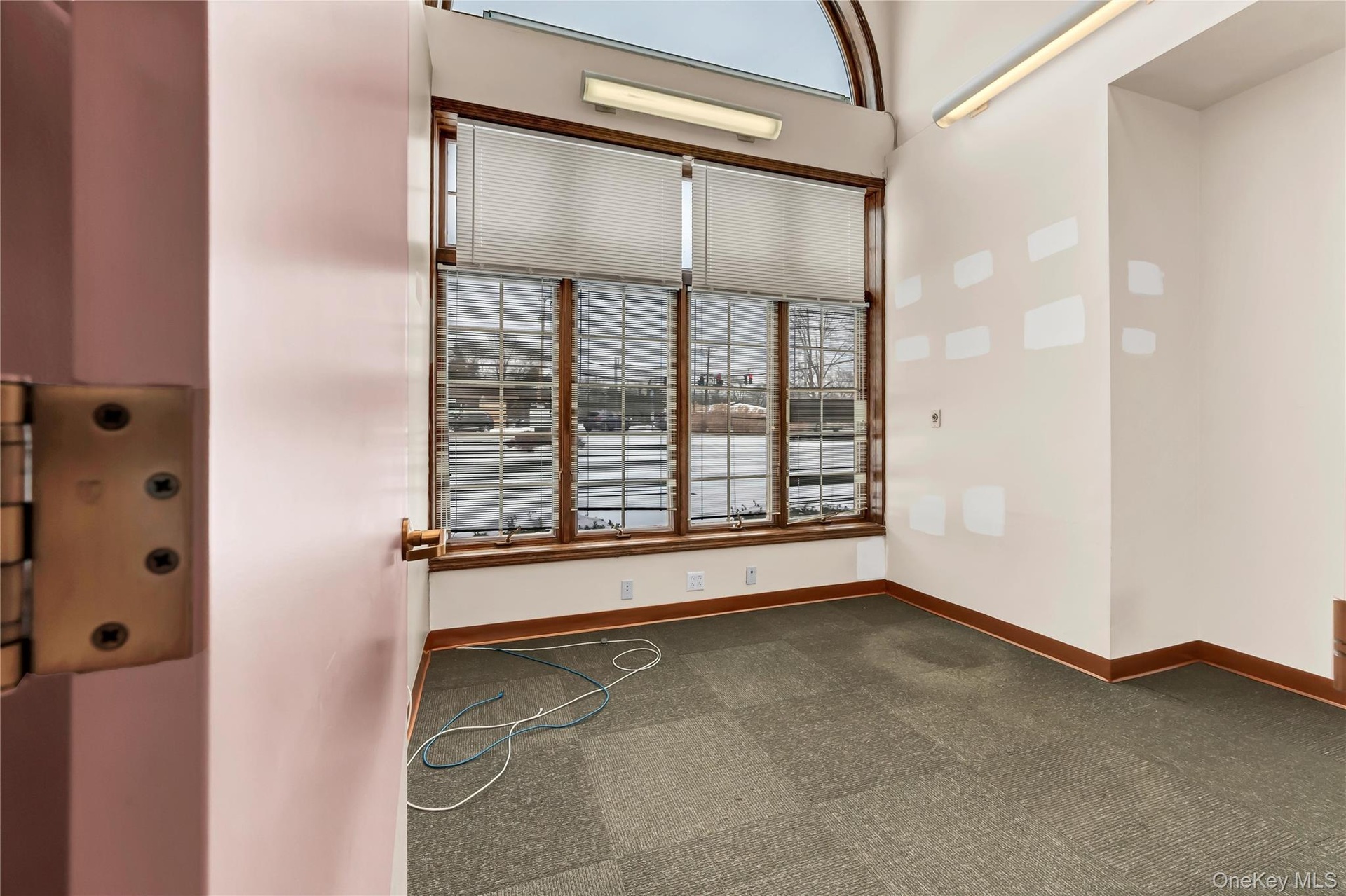 Spare room with dark carpet and elevator