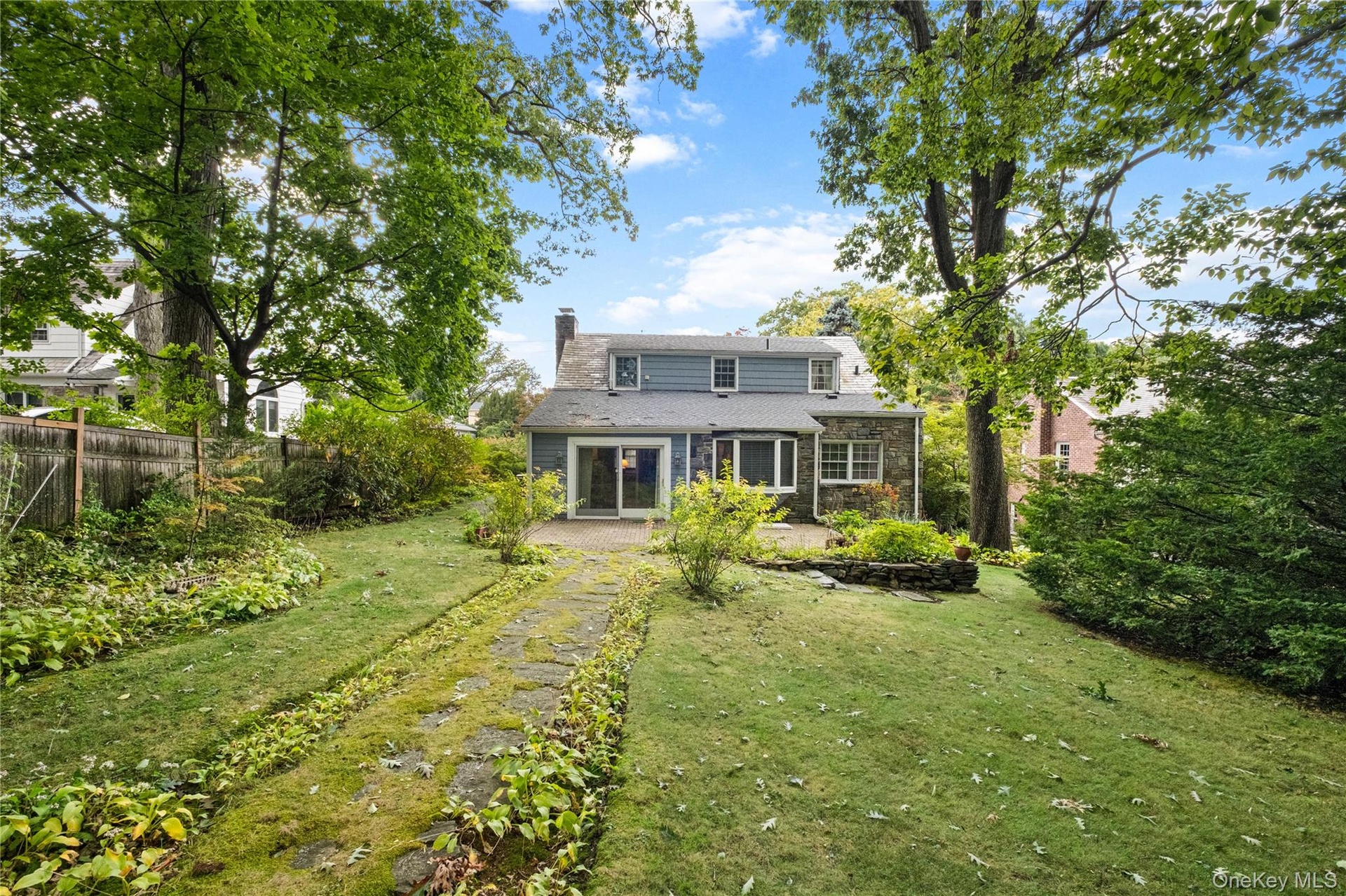 Back of home with patio and large grassy yard