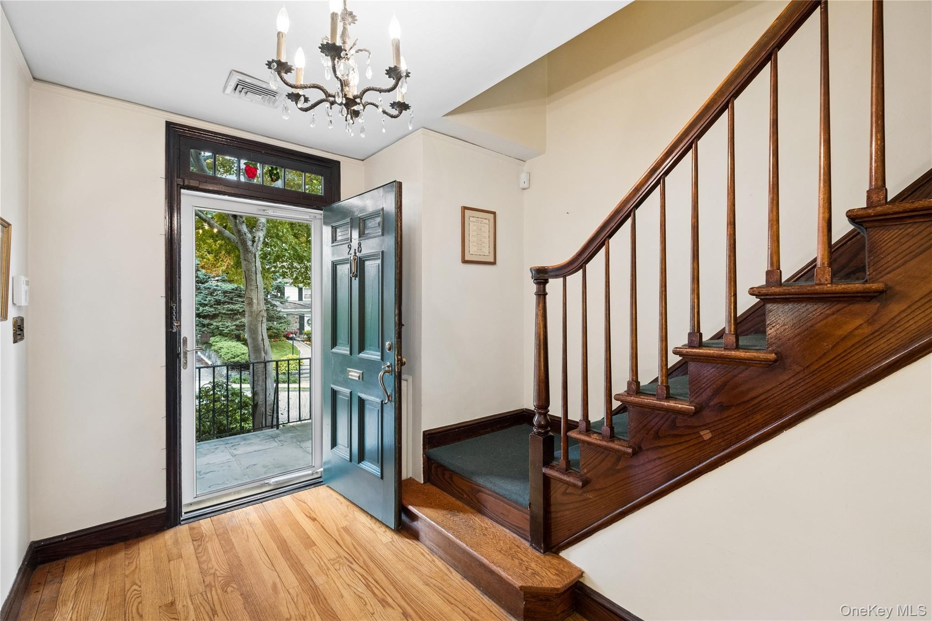 Front door has blue stone patio at the entrance.