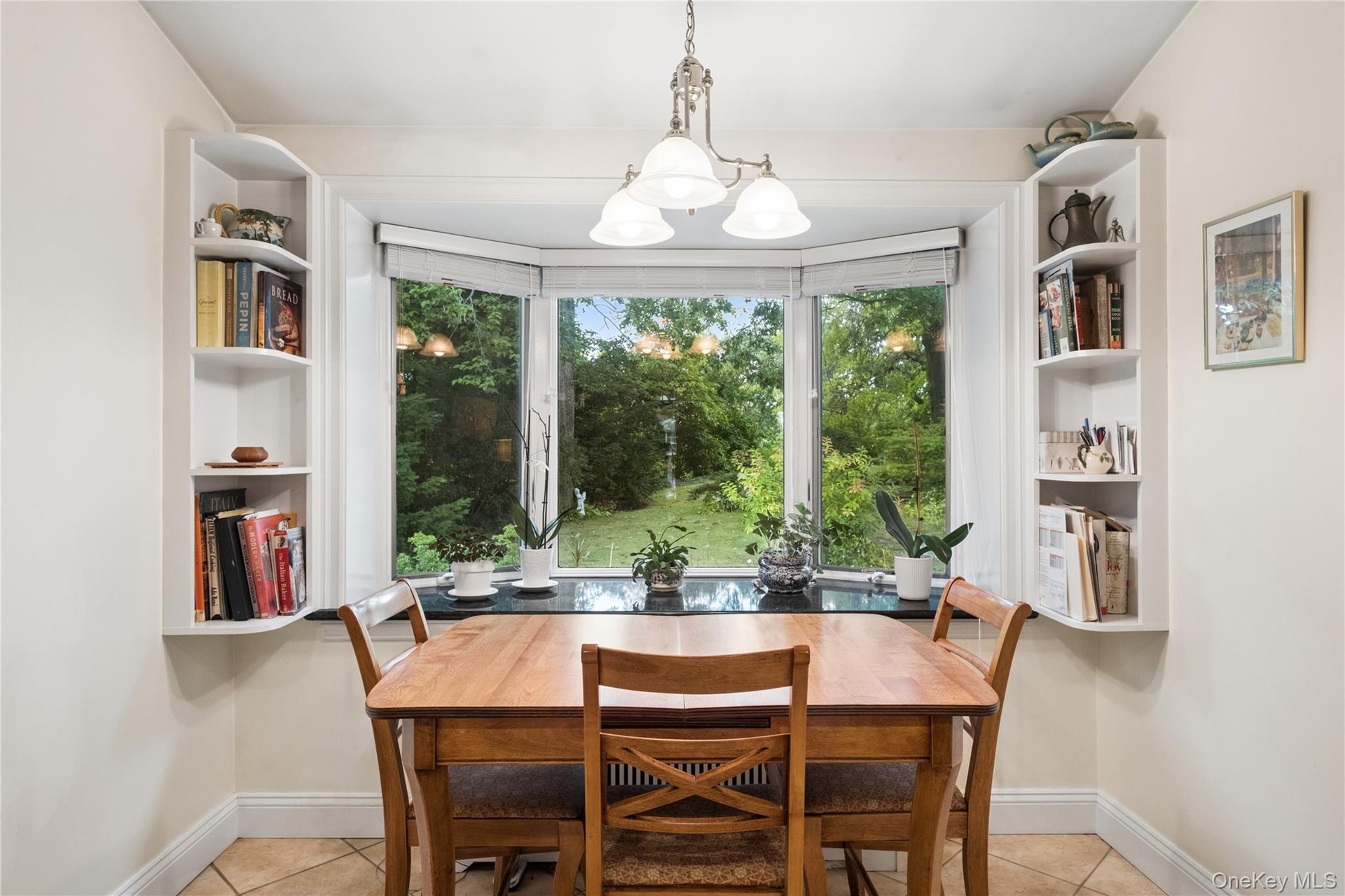 Kitchen dining area has view of backyard