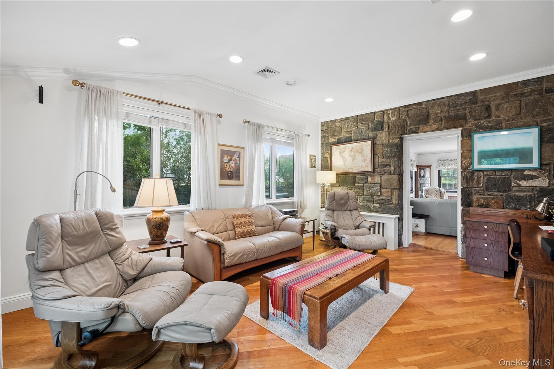 Family Room with Stone Accent Walls and wood flooring