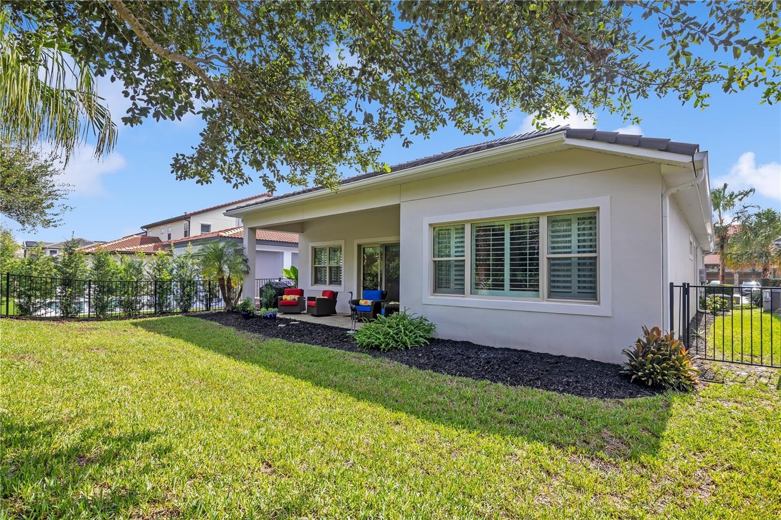eautifully maintained backyard with lush green lawn, mature landscaping, and attractive fencing.