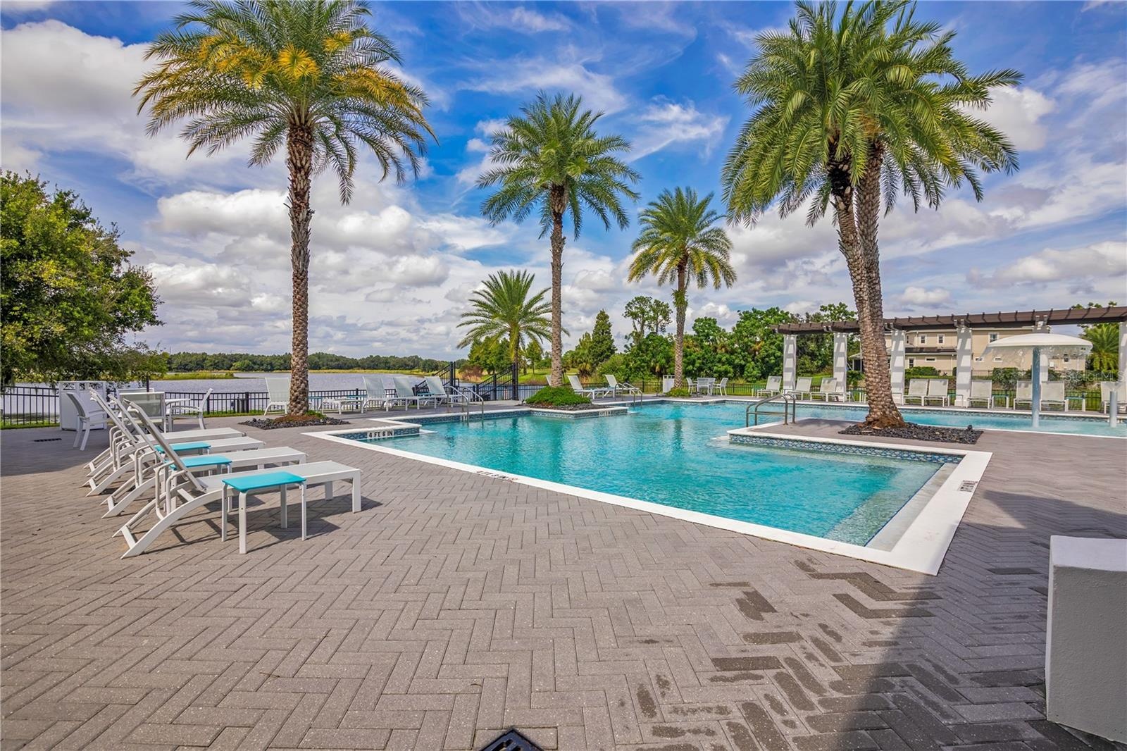 Relax and unwind at the stunning resort-style community pool surrounded by tropical landscaping.