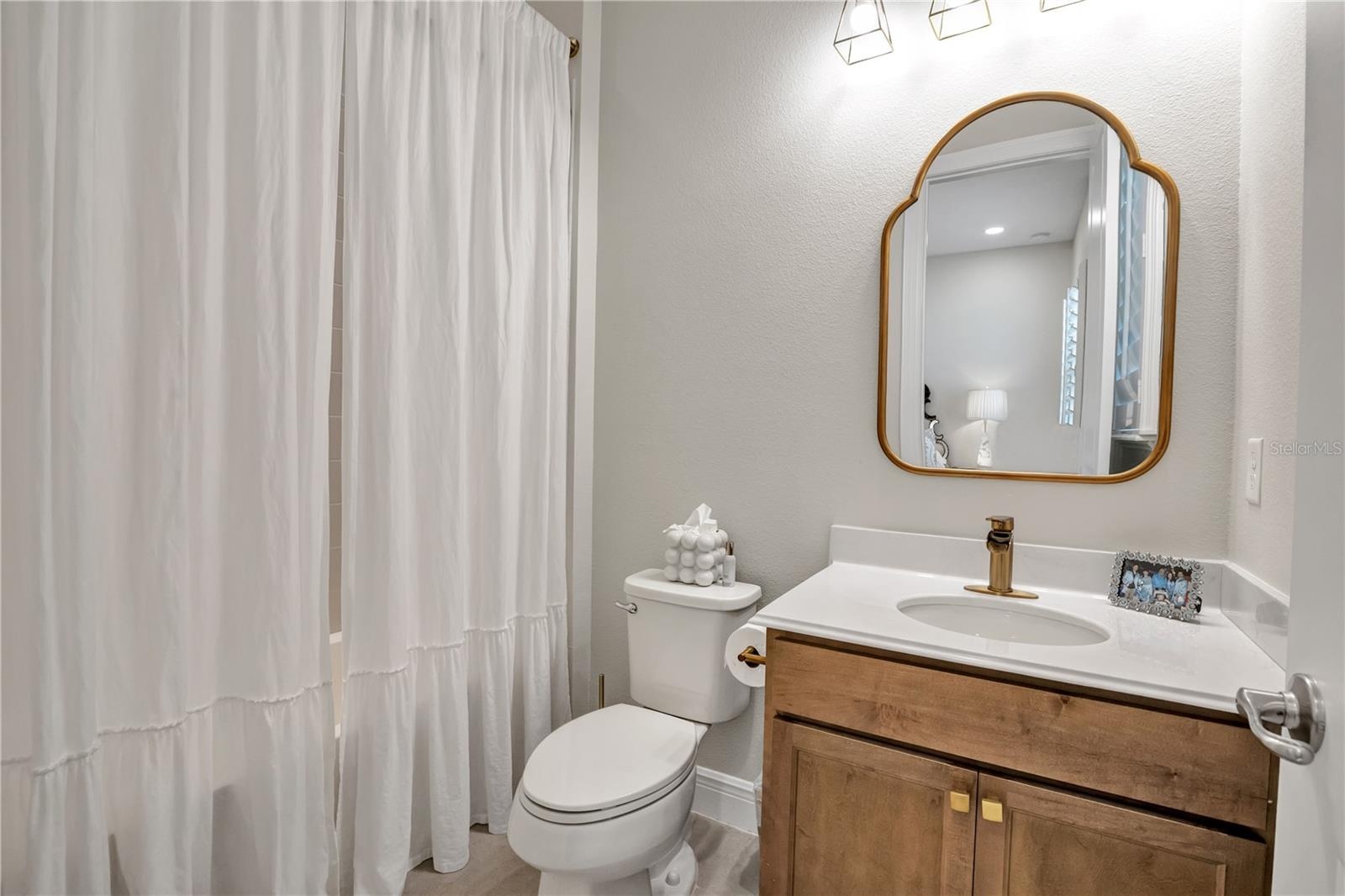Bright bathroom featuring a contemporary vanity and stylish fixtures.
