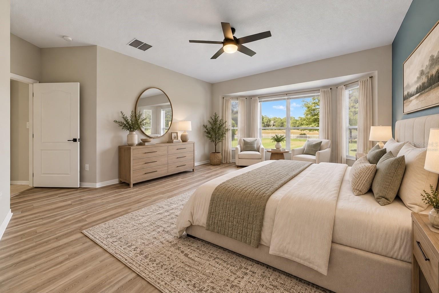 The FIRST-FLOOR PRIMARY SUITE presents a private retreat with LVP FLOORING and a bay window that fills the room with NATURAL LIGHT. Virtually Staged
