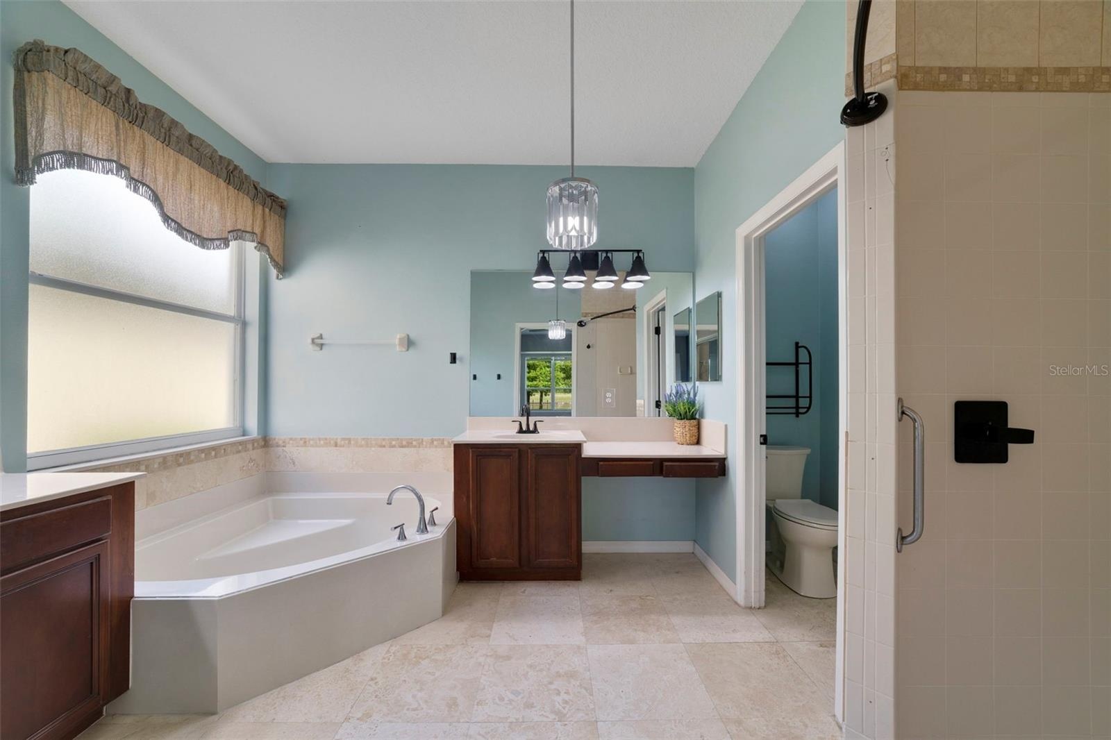 The Primary en suite Bath features dual vanities, a RELAXING GARDEN TUB, a step-in shower and a private water closet.