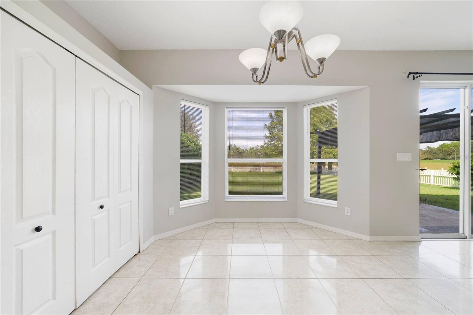 Stainless steel appliances and a SUNNY BREAKFAST NOOK with a bay window overlooking the backyard, complete this inviting space.