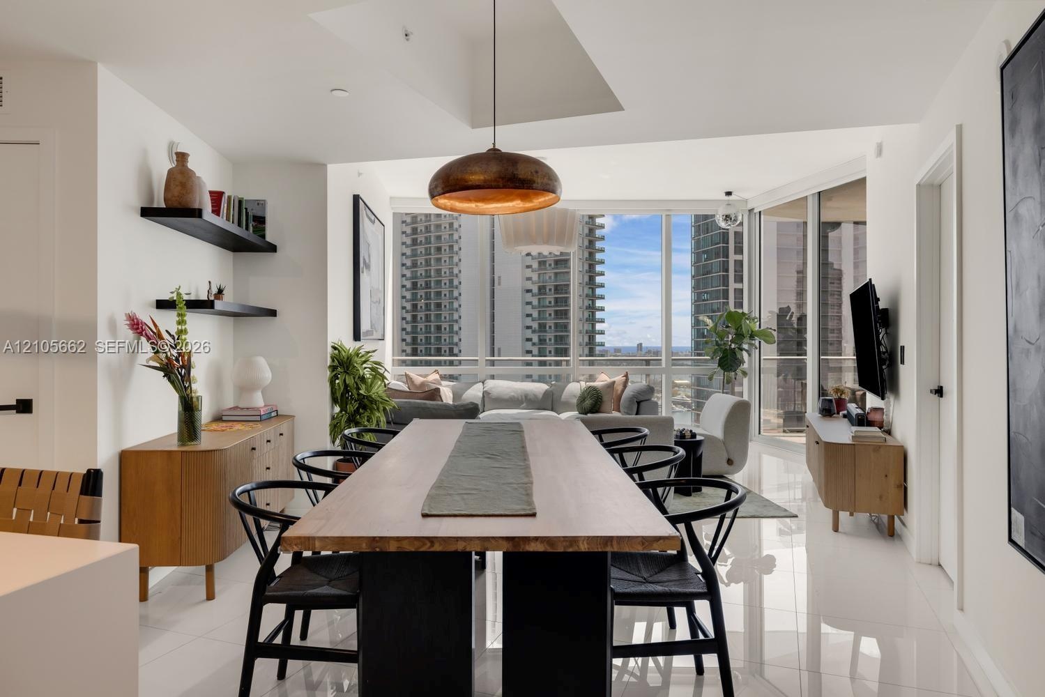 Open-concept space featuring floor-to-ceiling windows, polished tile flooring, recessed ceiling lighting, and matte black wall-mounted shelving