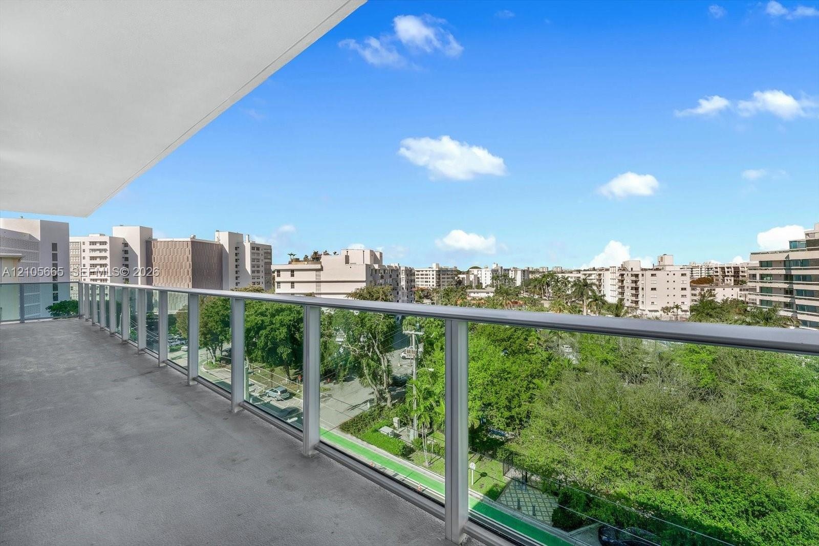 Covered balcony with a solid concrete floor and a glass-panel railing