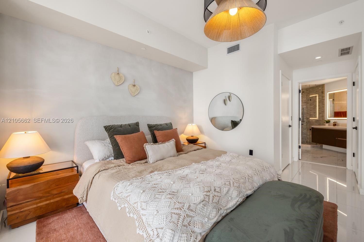 High-gloss flooring, recessed ceiling lighting, a textured accent wall, and a drum-style pendant light fixture