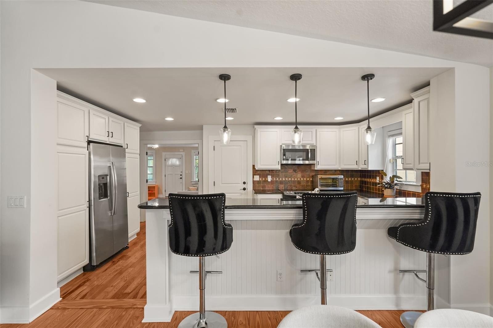 Kitchen with breakfast bar seating and pendant lighting