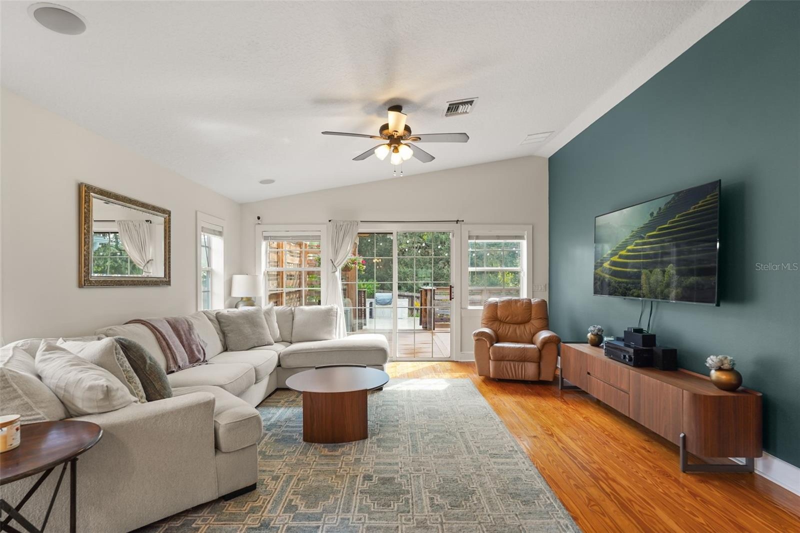 Living room with vaulted ceiling and accent wall