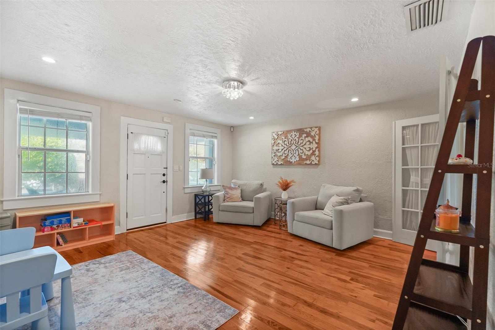 Front family room with wood floors and French doors