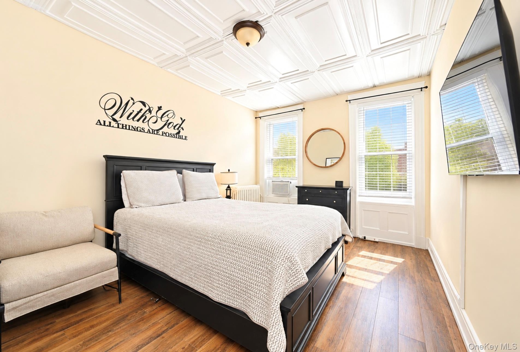 1st. Floor: Coffered ceiling with decorative detailing, wood-finish flooring, and double-hung windows with white paneled wainscoting