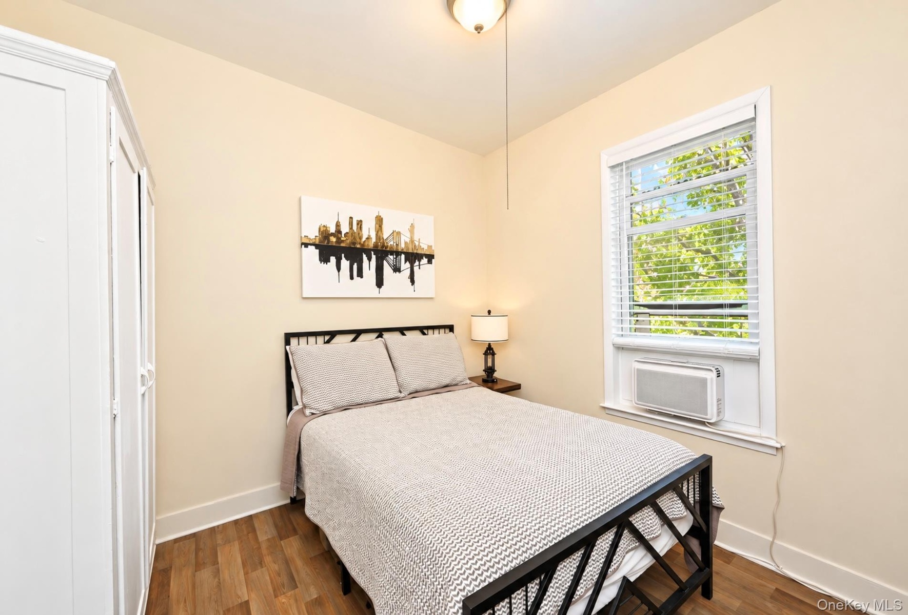 2nd. Floor: Neutral walls, wood-finish flooring, white trim, window with horizontal blinds, and a ceiling-mounted light fixture