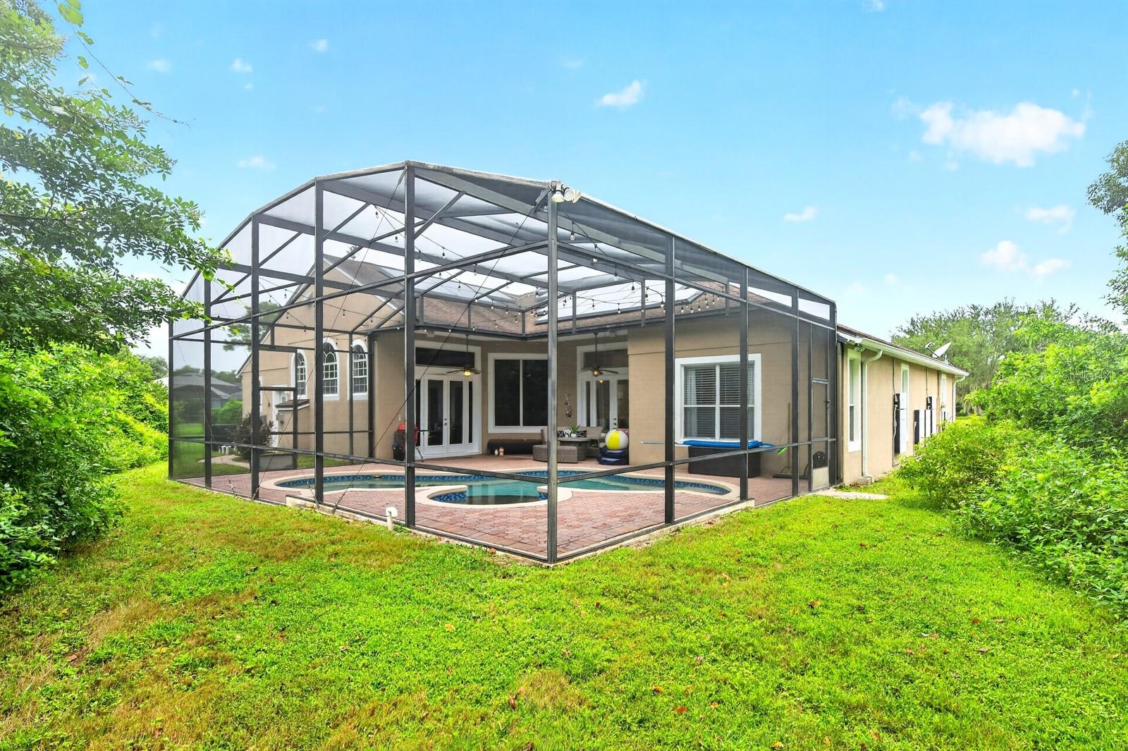 Mature trees add privacy to the screened pool.