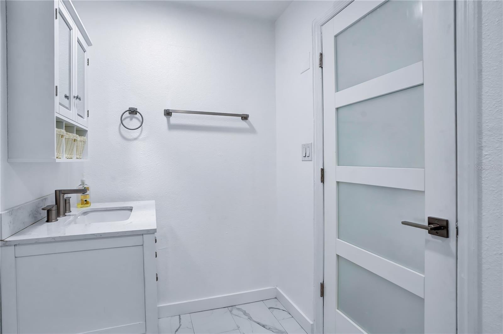Fully renovated primary bathroom with new door