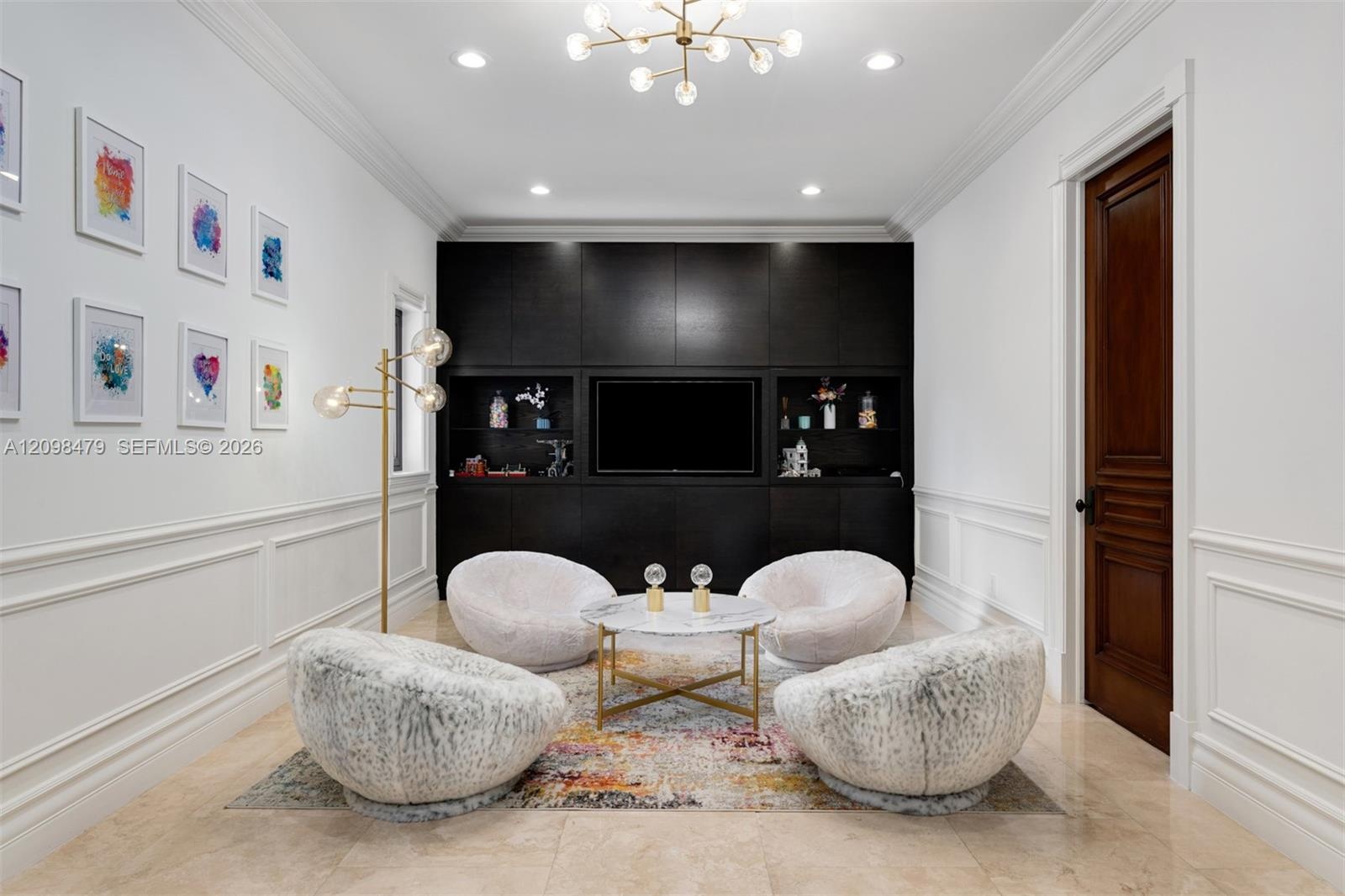 Recessed lighting with a modern chandelier, dark wood-finish built-in cabinetry, elegant wainscoting, and large format tile flooring
