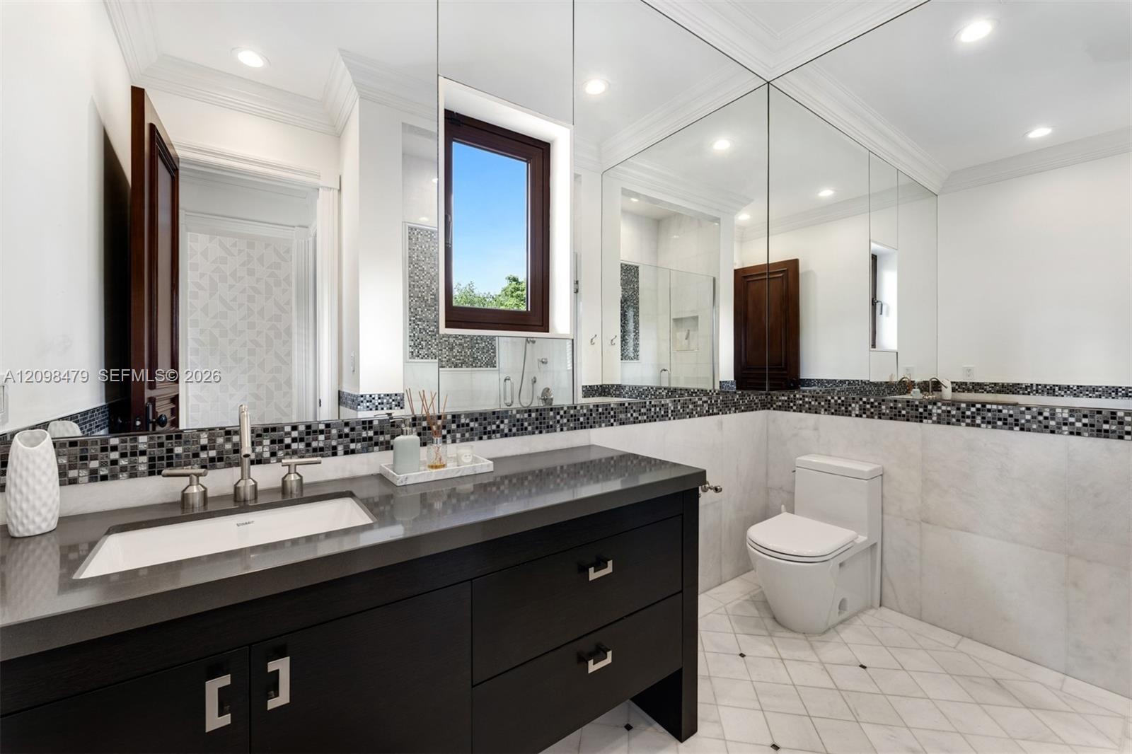Dark wood-finish vanity with a rectangular undermount sink and brushed nickel fixtures