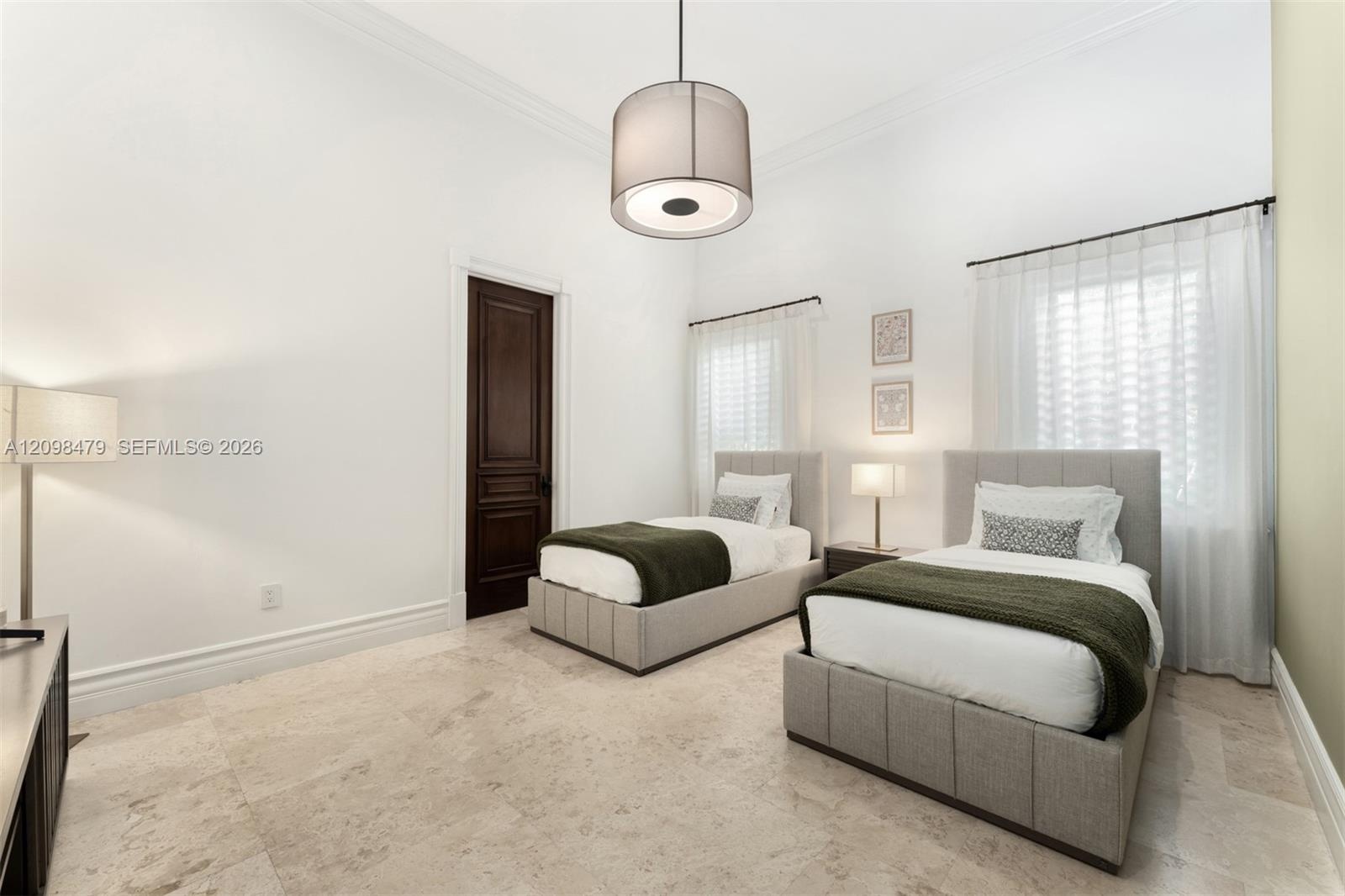 Recessed lighting and a drum pendant fixture illuminate the space