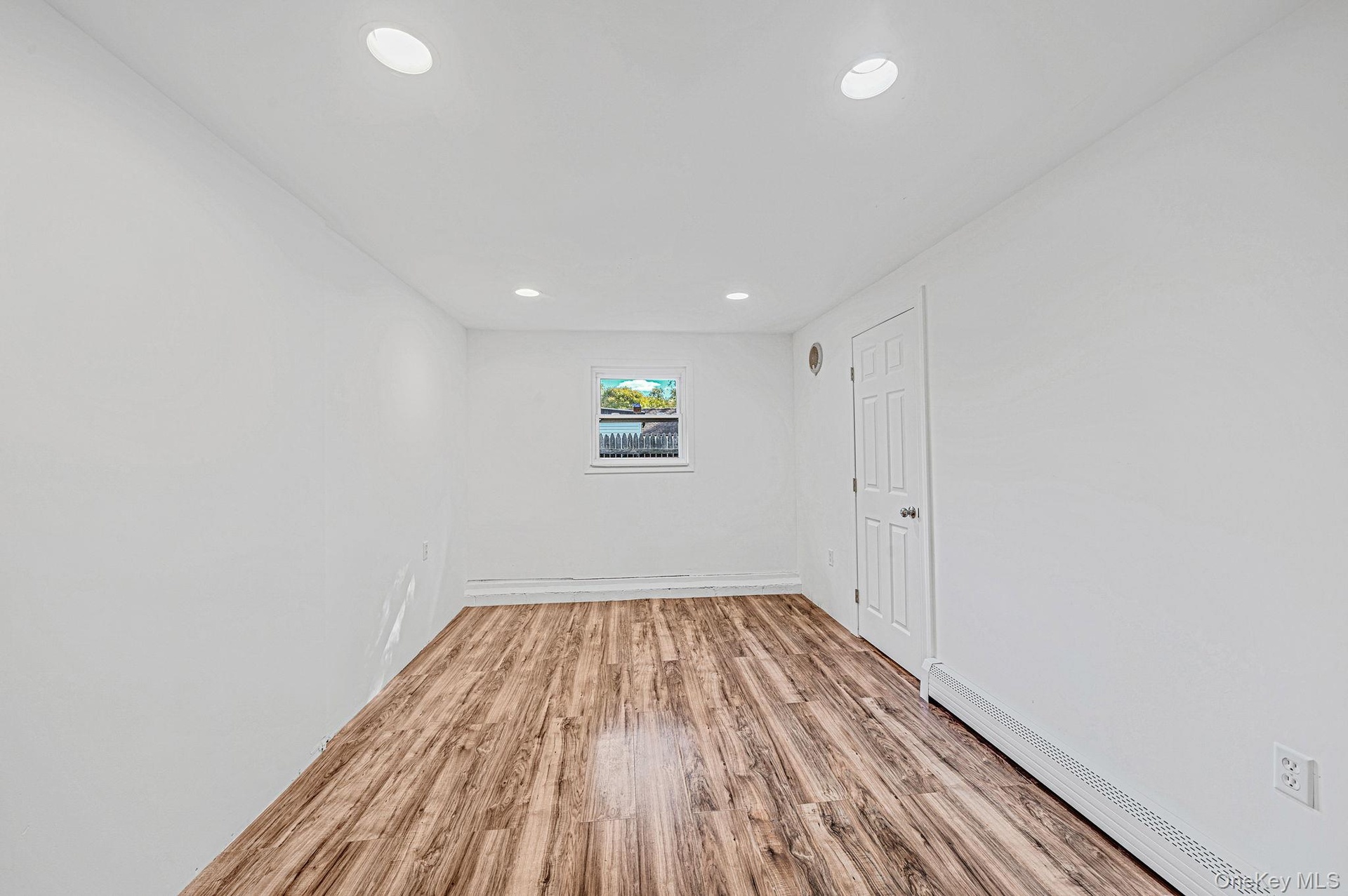 1st floor bedroom located in rear extension features laminate flooring, and recessed lighting.