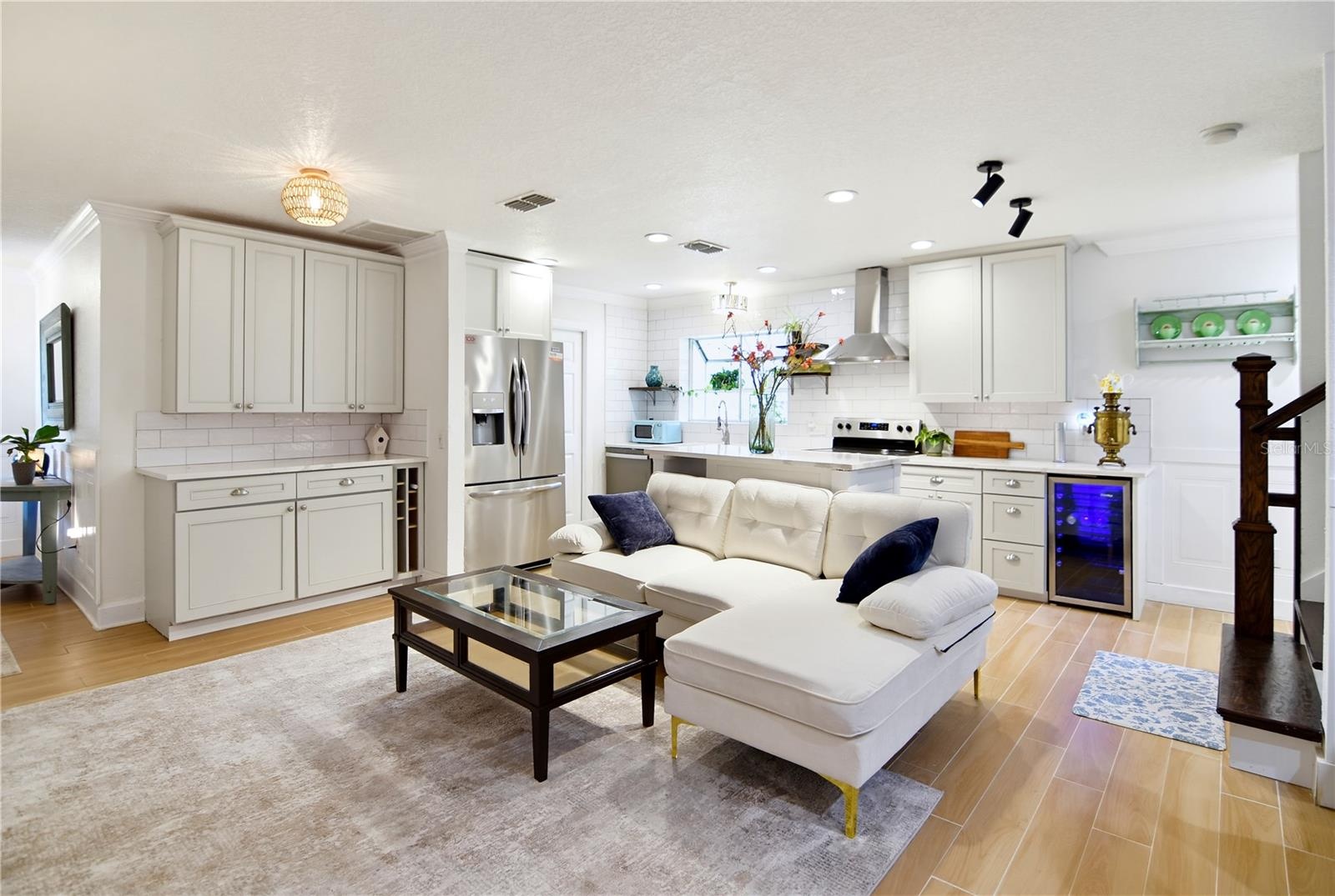 Spacious main living area with natural light, warm flooring, and an open-concept design.