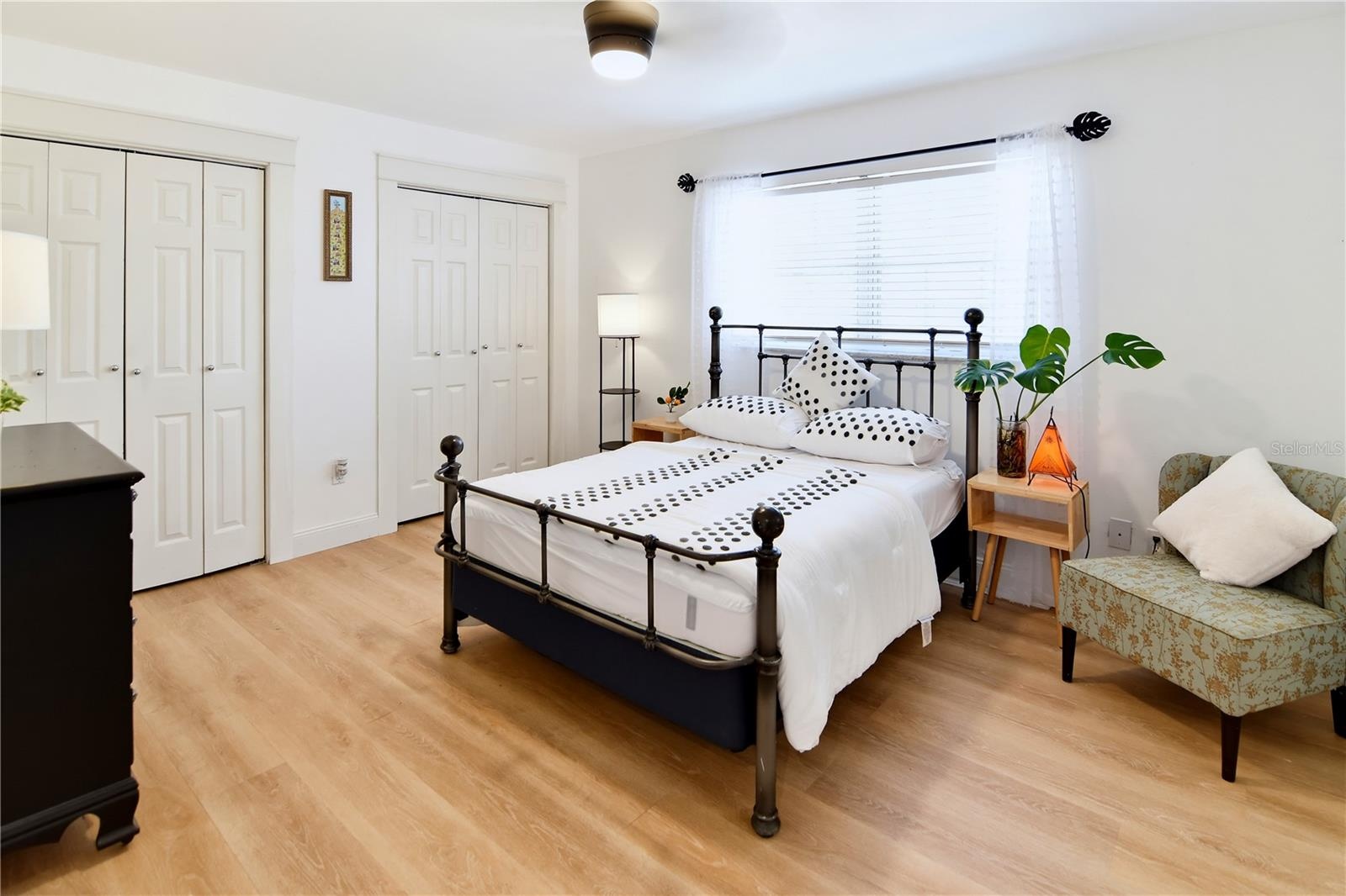 Comfortable downstairs bedroom with natural light and updated flooring.