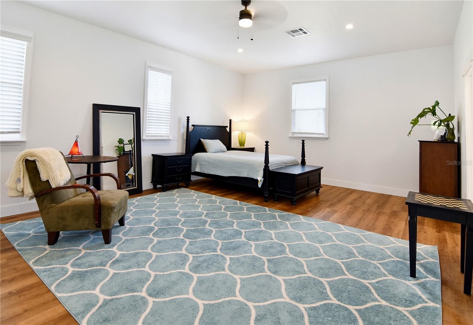 Private primary retreat featuring generous proportions and attractive wood-look flooring.