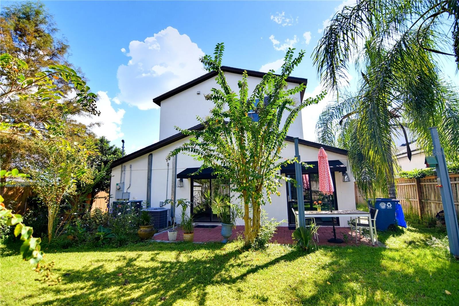 Private fenced backyard with mature landscaping and space for outdoor enjoyment.