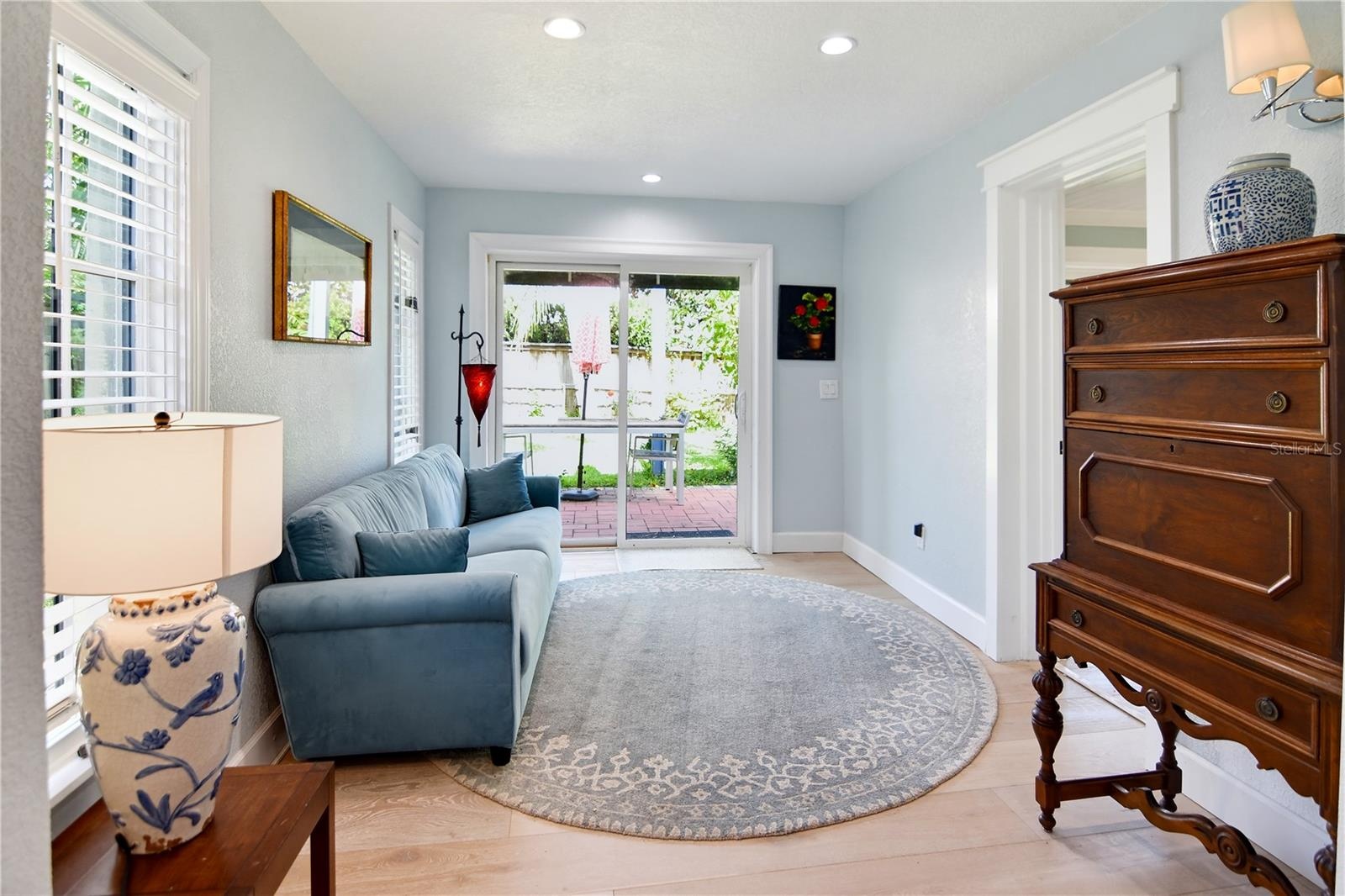 Charming sitting room with sliding glass doors opening to the backyard.