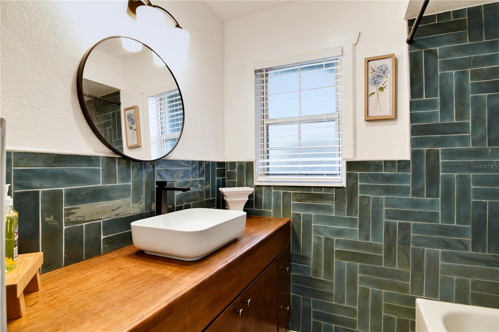 Beautifully appointed bathroom with distinctive tilework and updated fixtures.