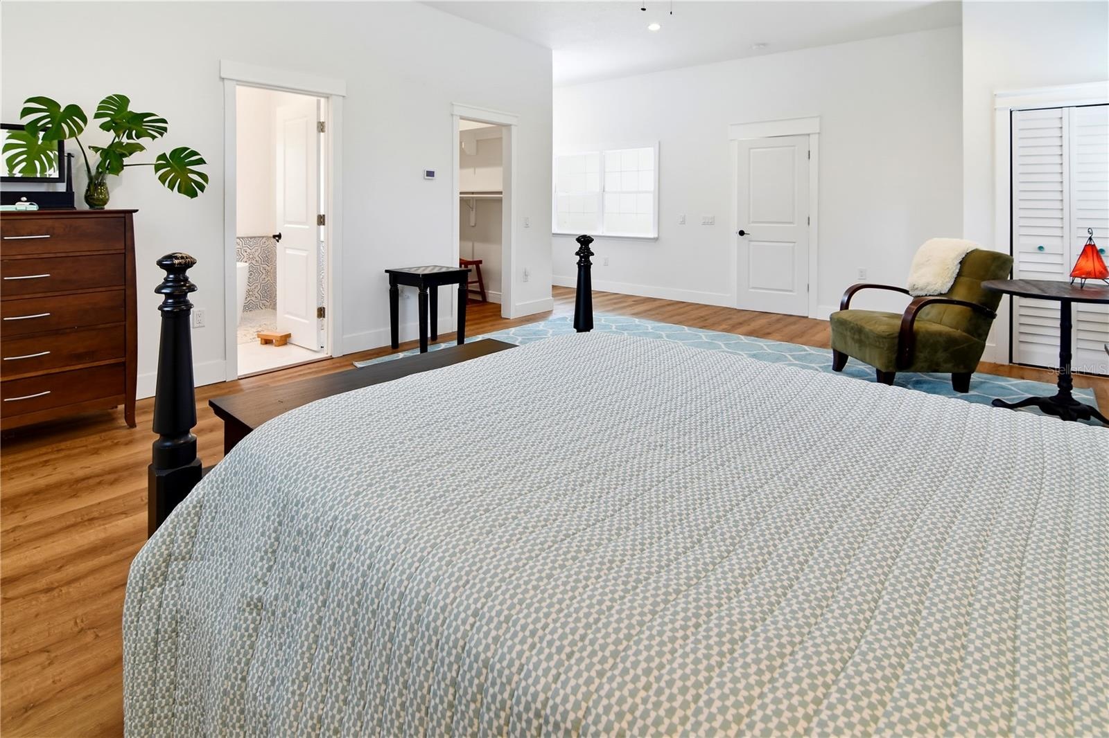Another perspective of the primary bedroom, showcasing its flexible layout and generous space.