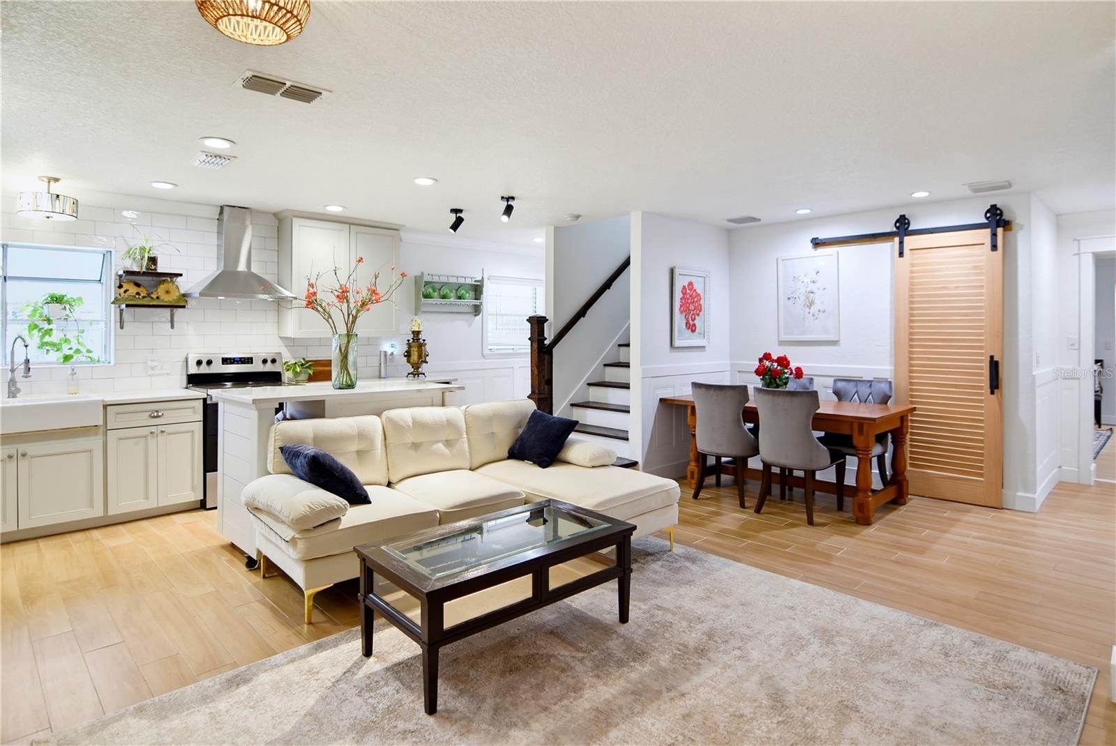 Open layout seamlessly connects the kitchen, living room, and dining area.