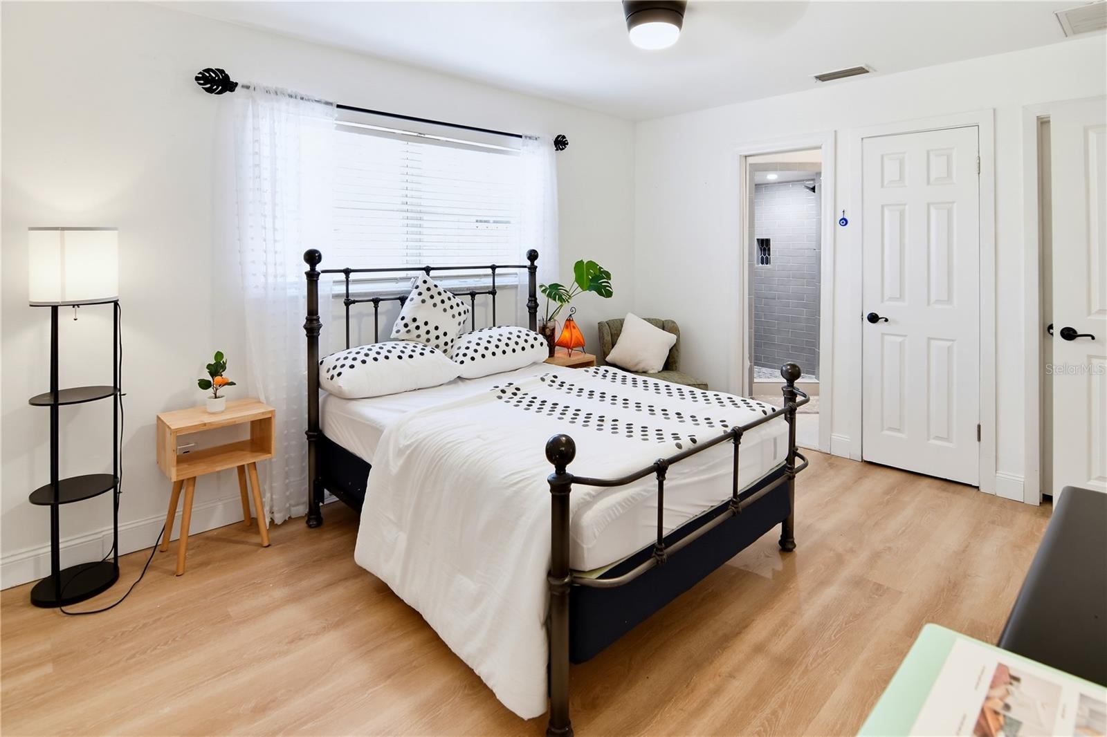 Another view of the downstairs bedroom, featuring ample space for furnishings.