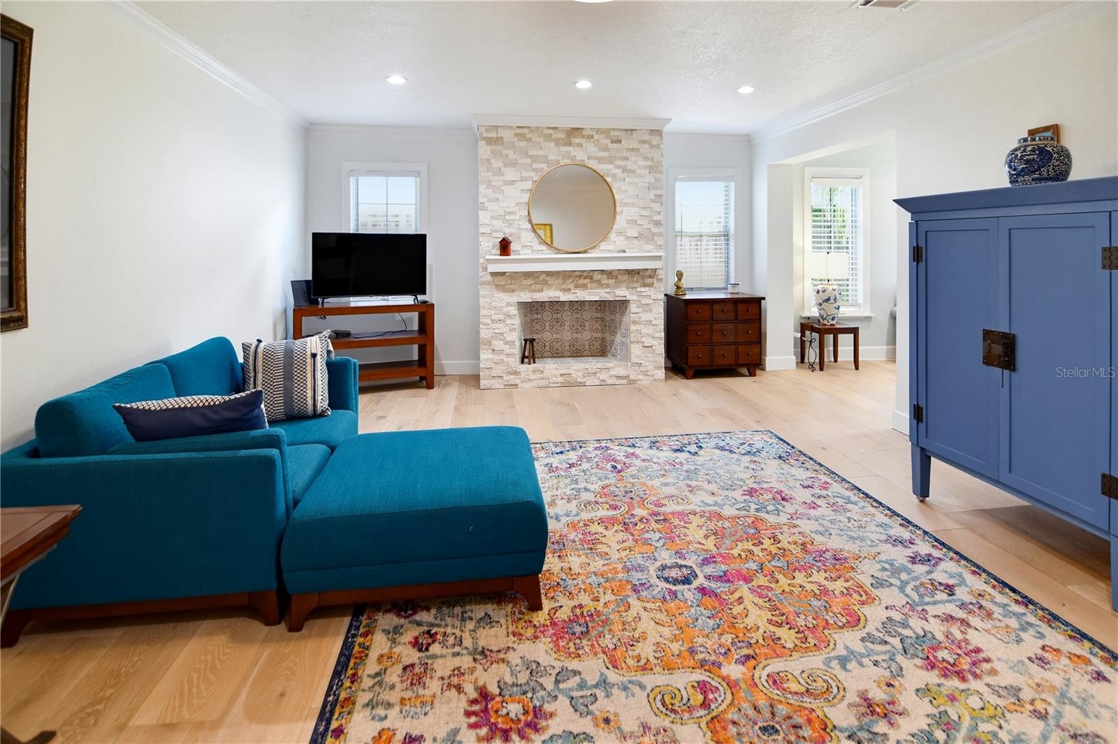 Another view of the family room, showcasing the fireplace and custom built-ins.