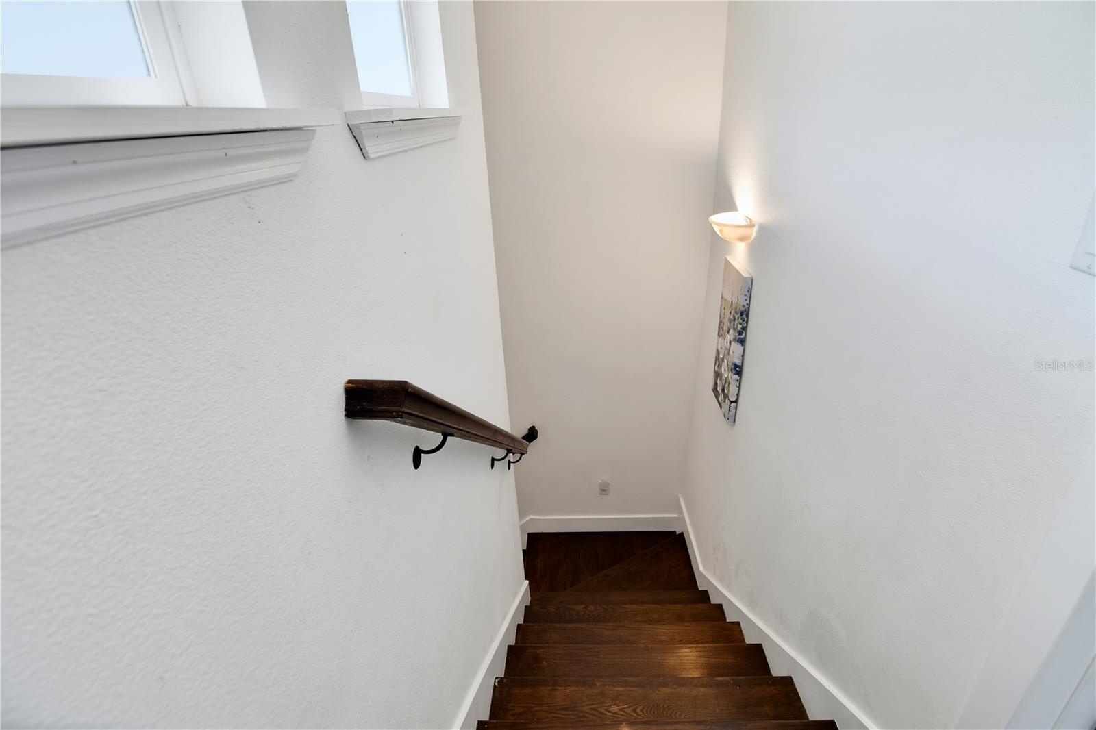 Additional staircase view with natural light and attractive wood accents.