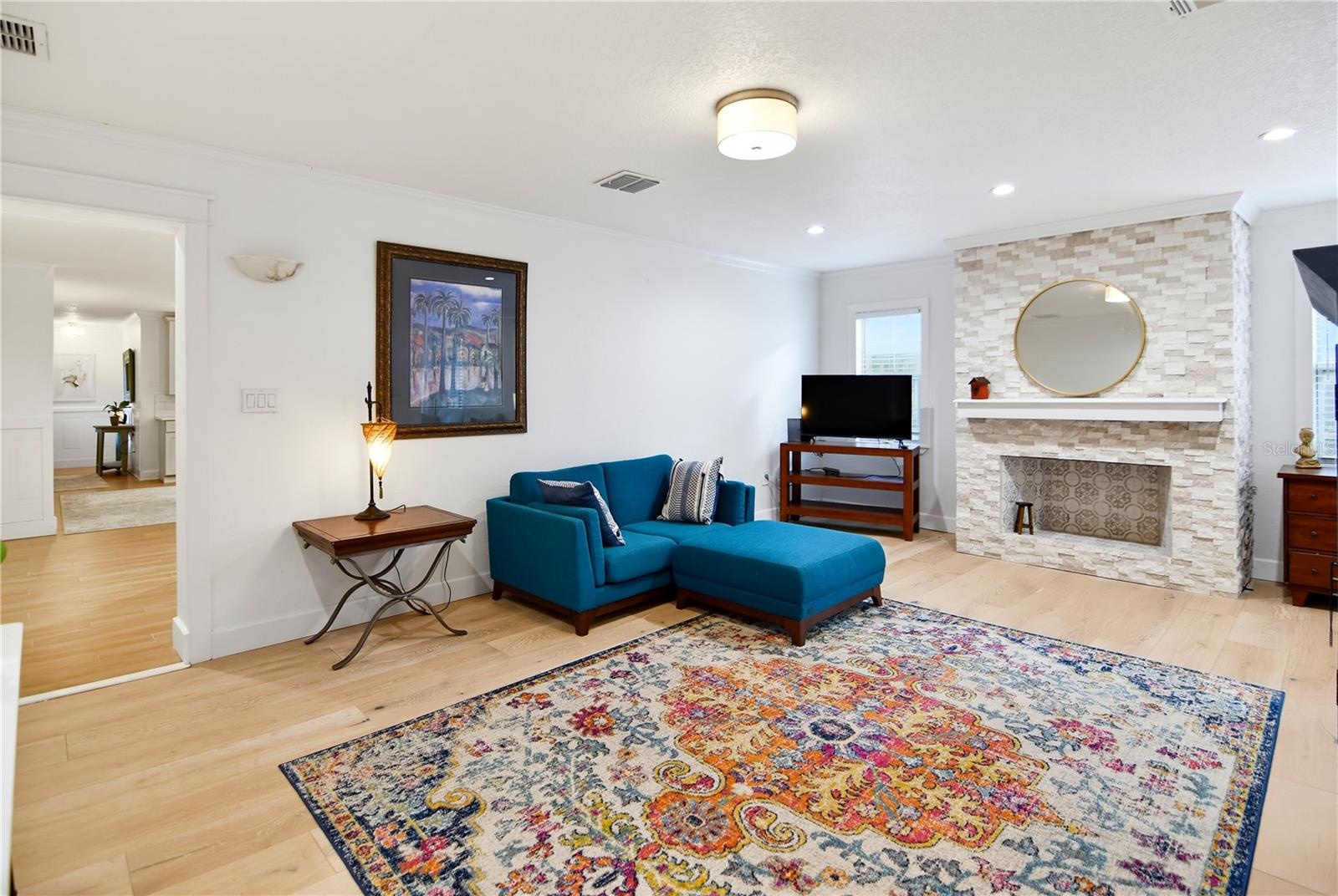 Beautiful stone wood-burning fireplace serves as a focal point of the family room.