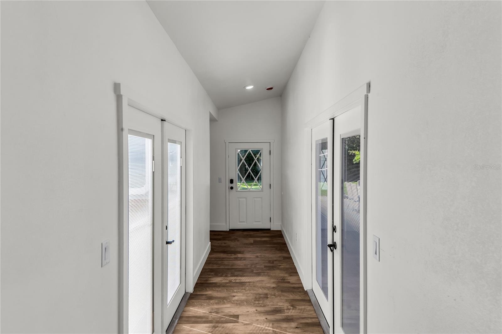 Private hallway leads to newly designed Primary Suite. French Doors lead to pool and backyard on one side and private courtyard on opposite side.