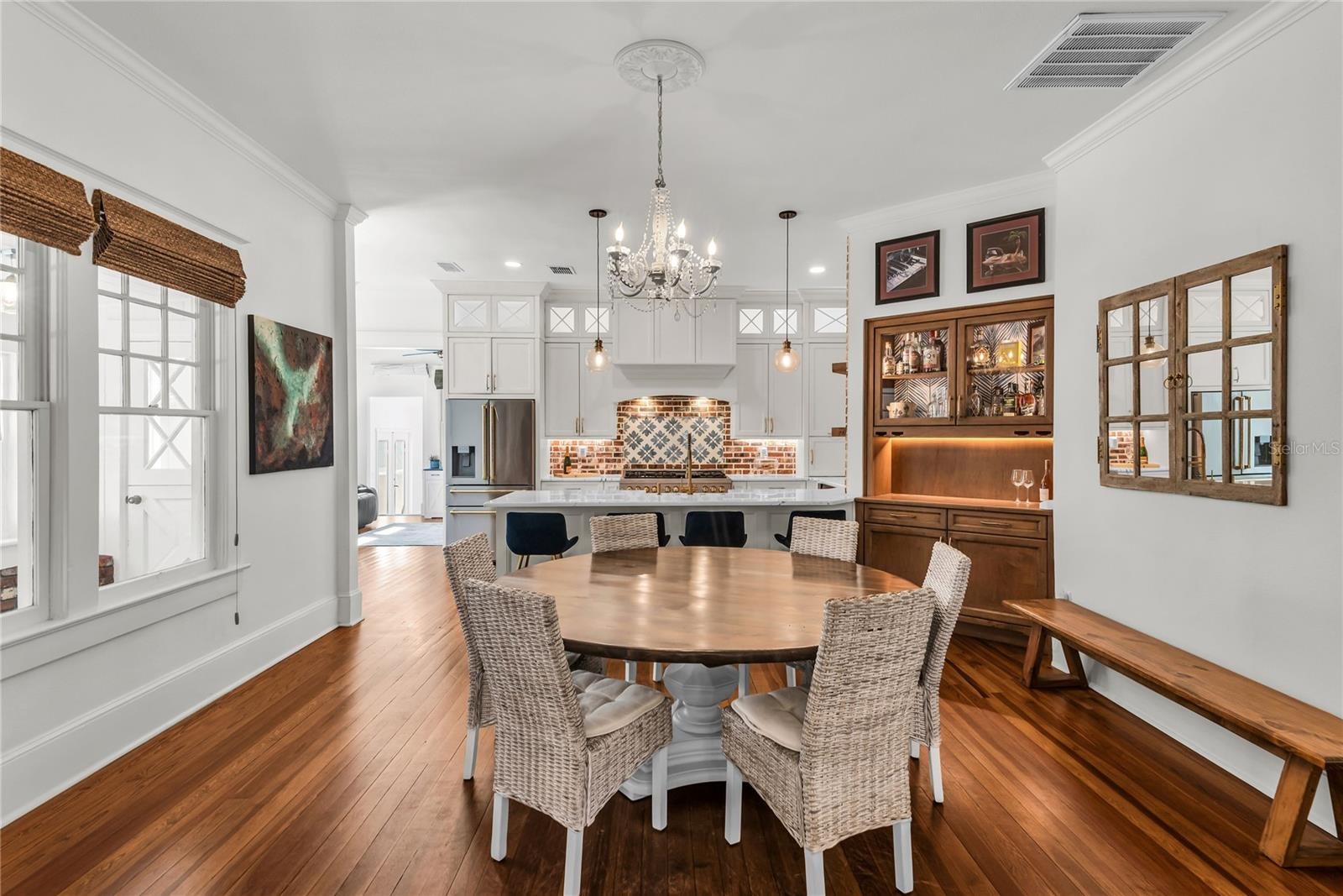 The Formal Dining room offers a seamless connection to the kitchen while maintaining its own distinct character. A custom built-in beverage bar serves