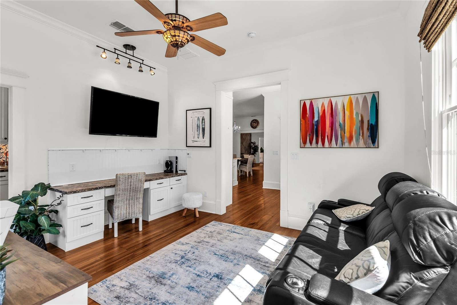Home Office with custom built in desk and access to laundry room.