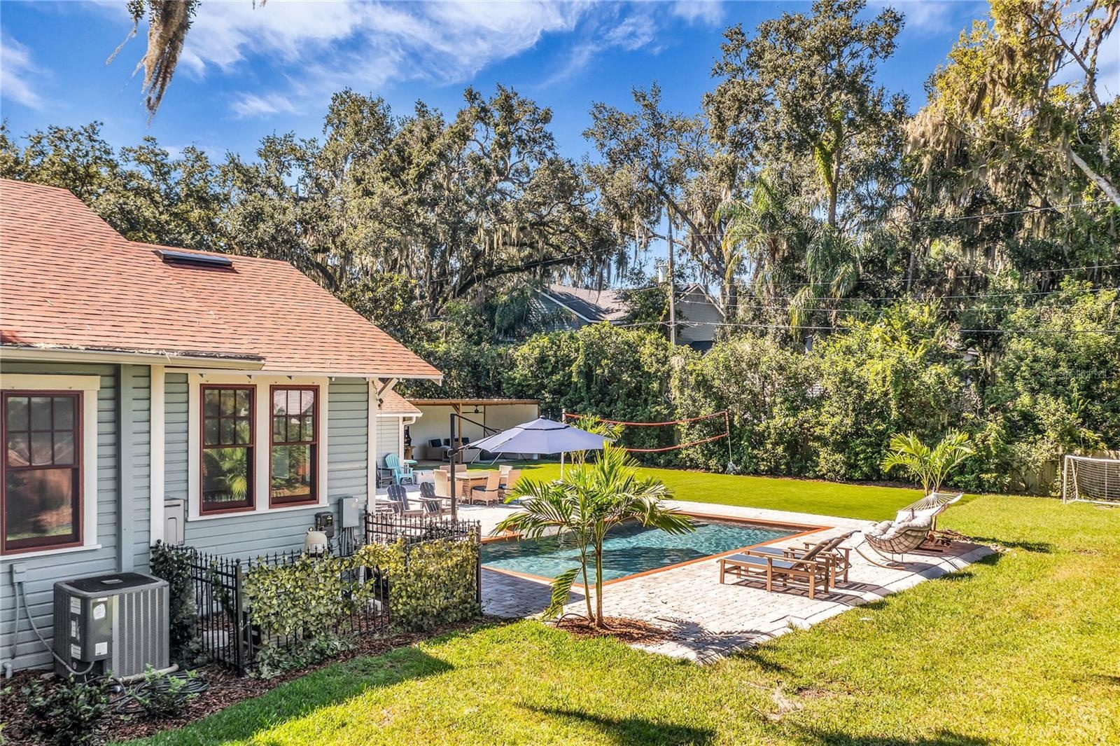 The enormous fully fenced backyard is designed for year-round enjoyment with a gas-heated saltwater sport pool, outdoor kitchen, expansive brick paved