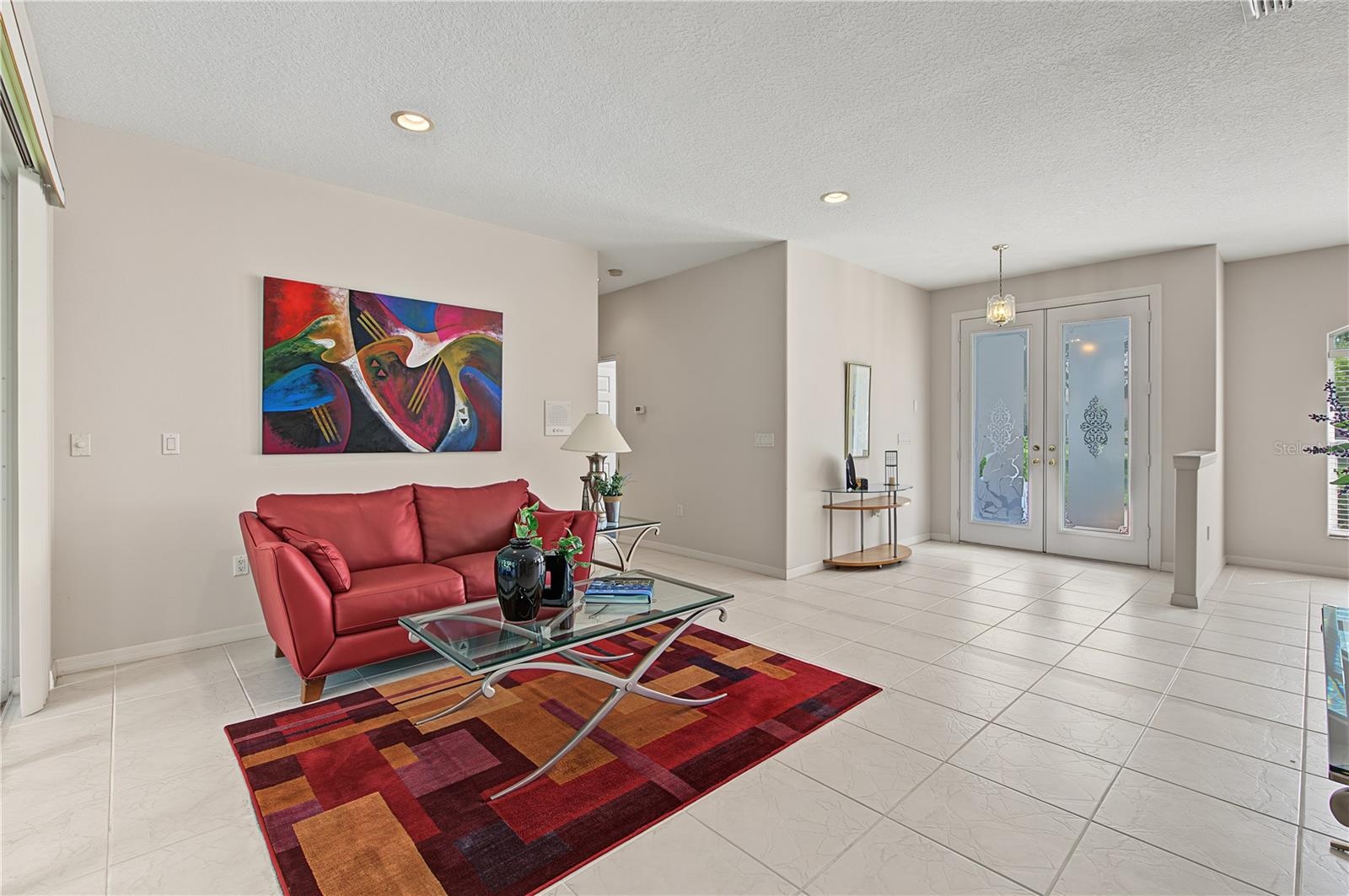 Double Front Doors entryway to the living room along with tile Flooring