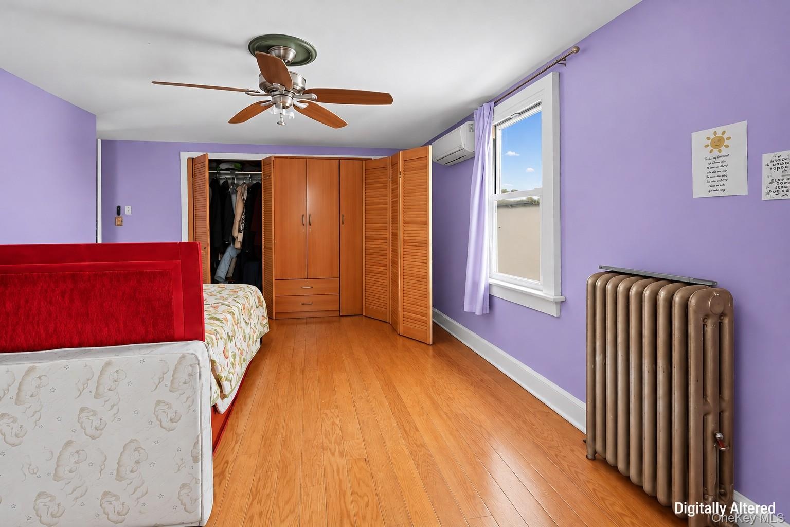 Hardwood-finish flooring, white window trim, and a ceiling fan with integrated lighting