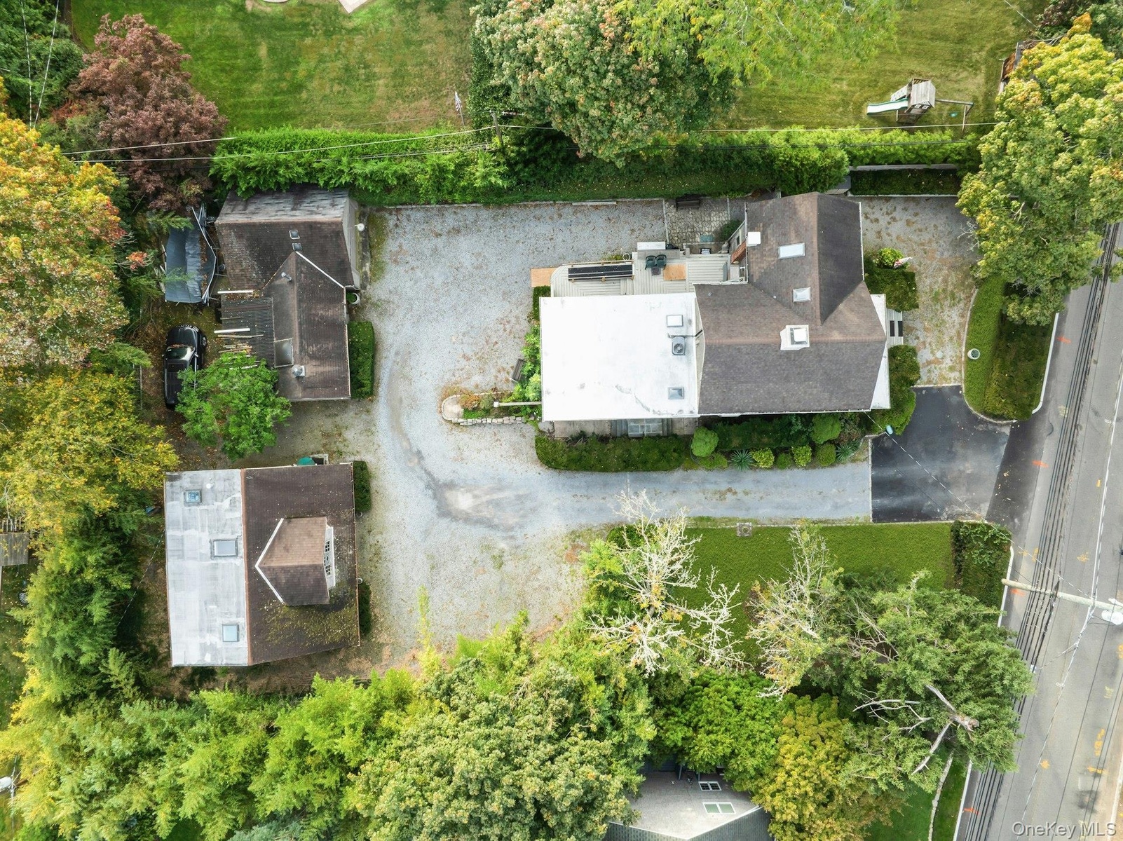 Expansive gravel driveway providing ample parking