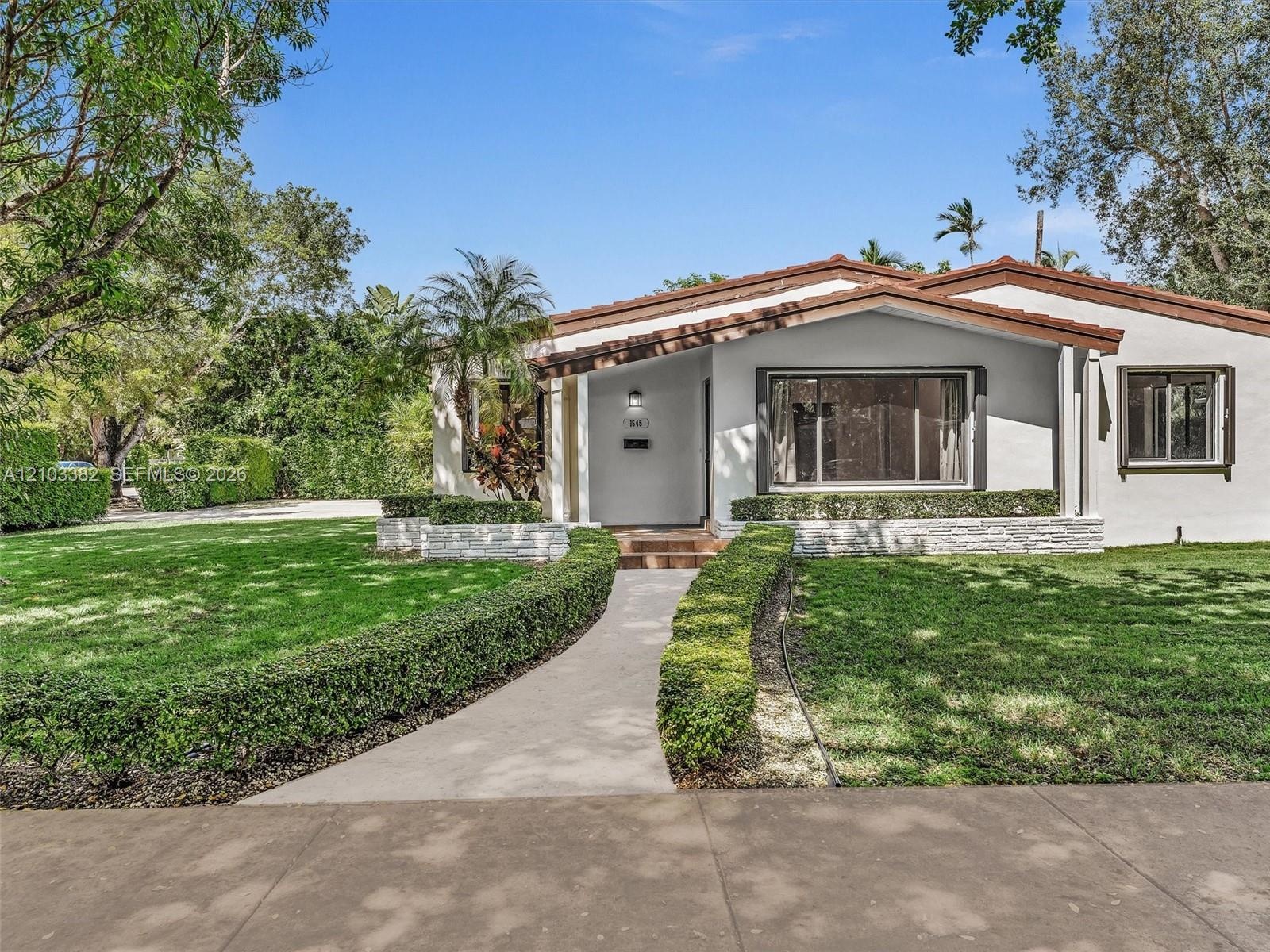 Single-story house set deep on a large lot in Coral Gables within walking distance to University of Miami and minuted from South Miami shops/ cafes. S
