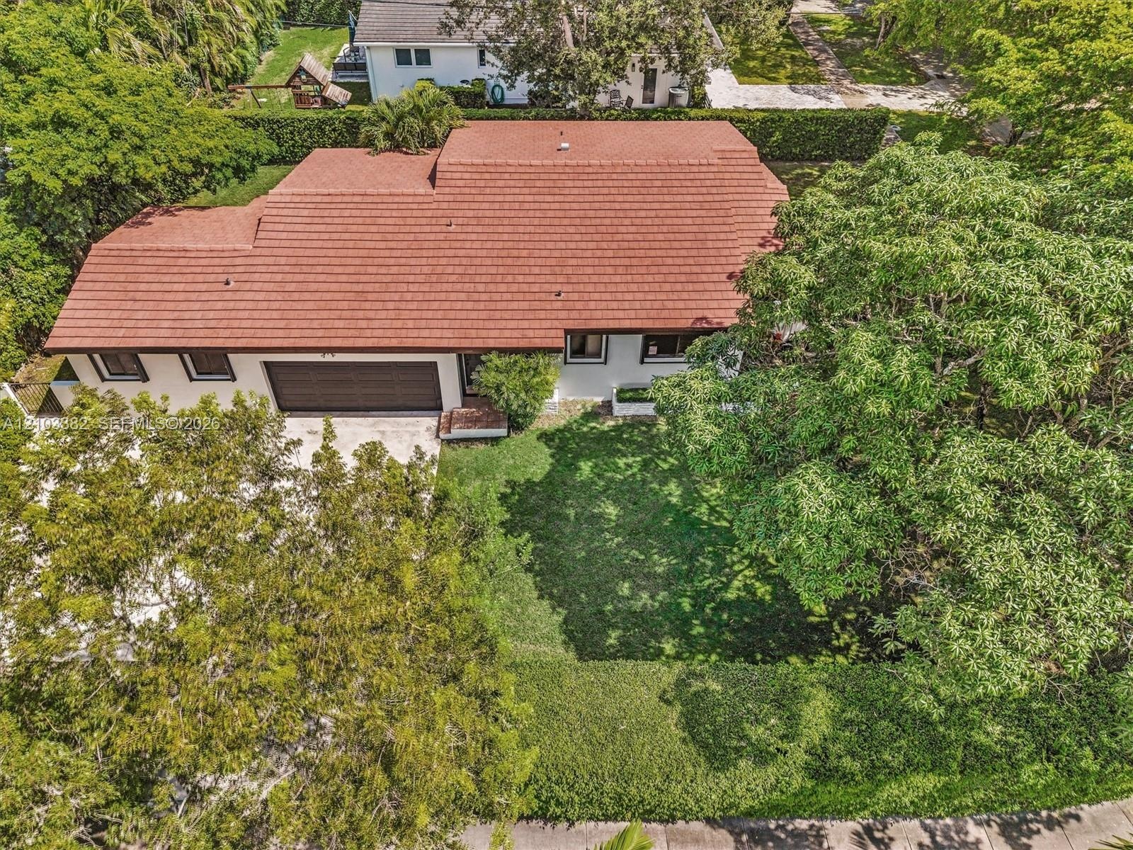 Single-story house for rent on a huge corner lot, featuring a tile roof, an attached two-car garage, and established landscaping.House for rent in Cor