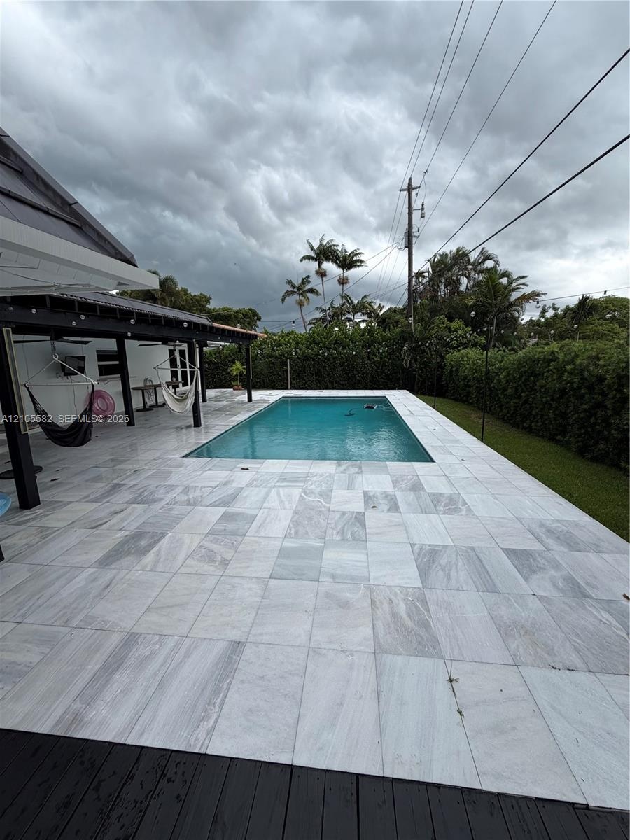 Rectangular swimming pool with white tile surround