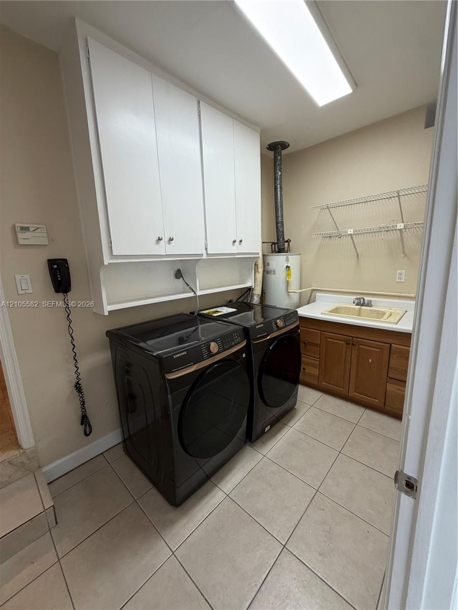 Laundry room with tiled flooring, white upper cabinetry, a utility sink, and wall-mounted shelving