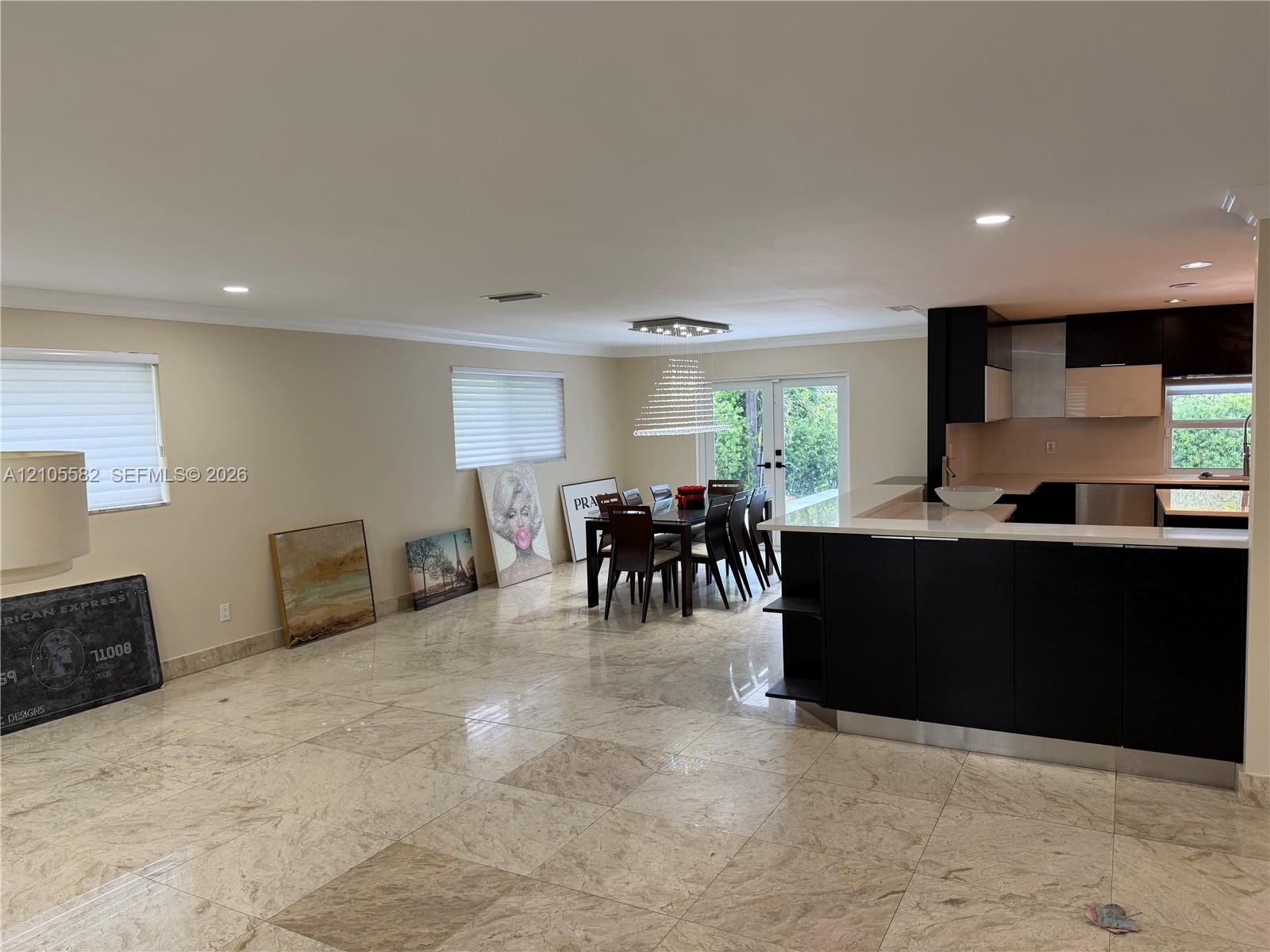 Tile flooring, recessed lighting, modern kitchen cabinetry, breakfast bar, and glass doors