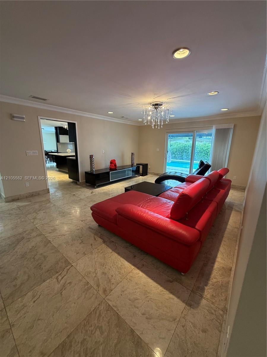 Recessed lighting, crown molding, and large format tile flooring